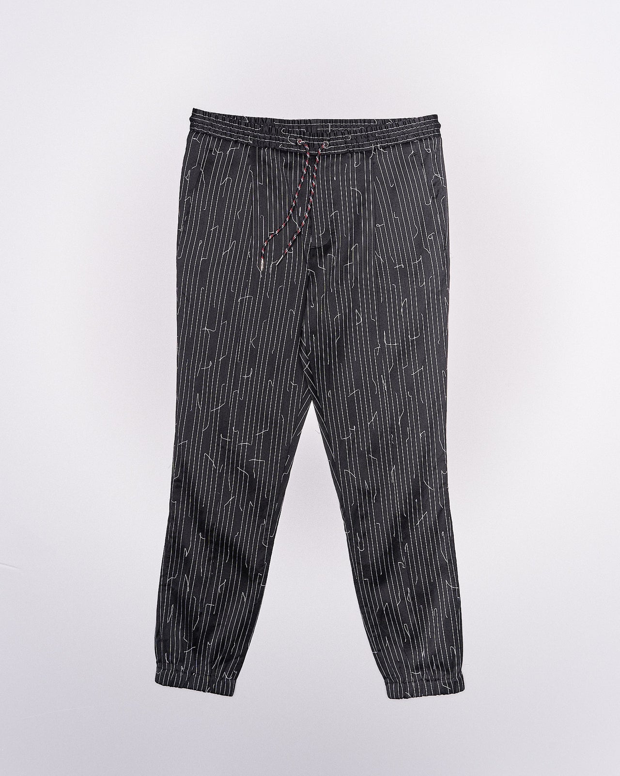 A pair of Dior pinstripe pants with drawstrings, elasticized waistband, side and back flap pockets, and embroidered detail.