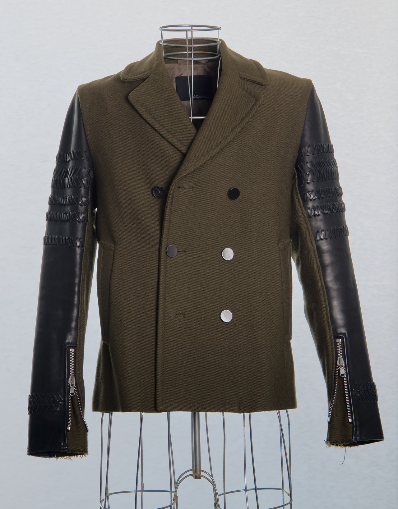 Brown 3.1 Phillip Lim coat with leather sleeves on a mannequin against a white background