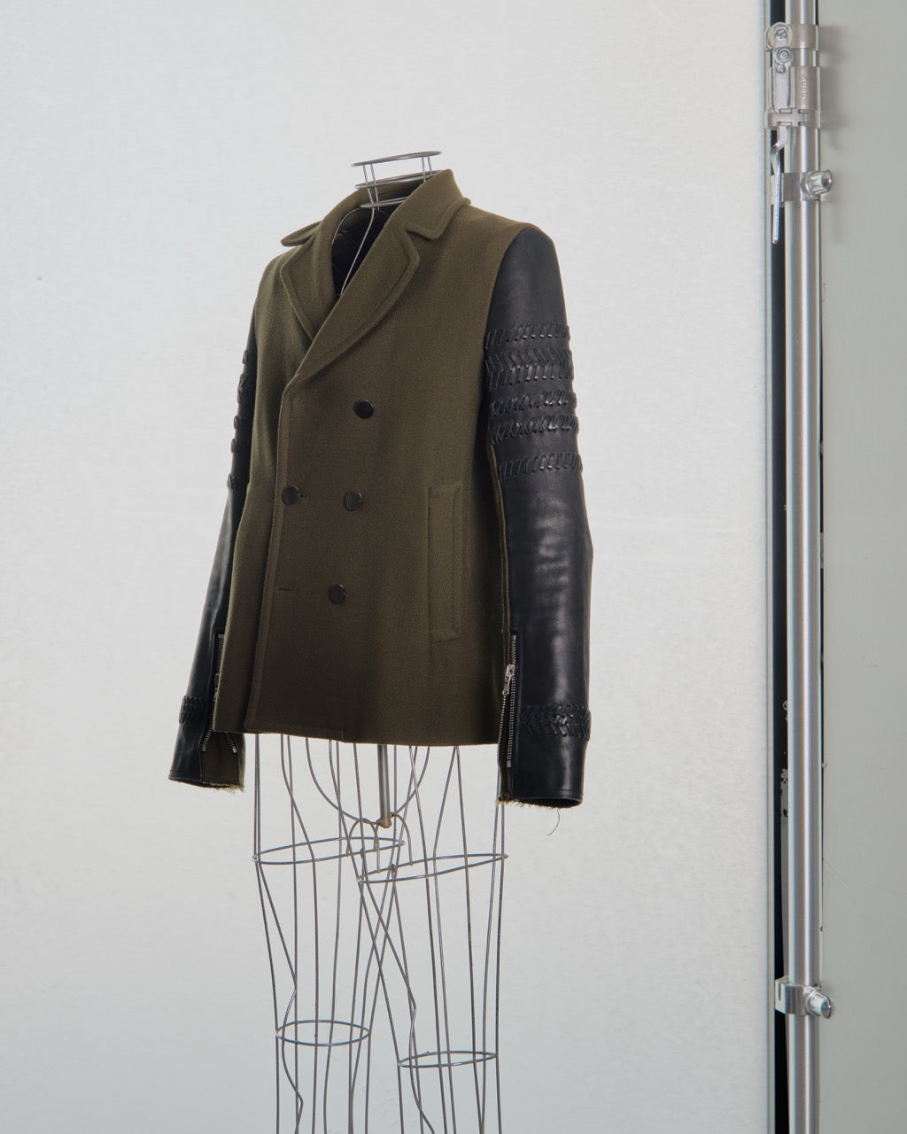 Brown 3.1 Phillip Lim coat with leather sleeves on a mannequin against a white background