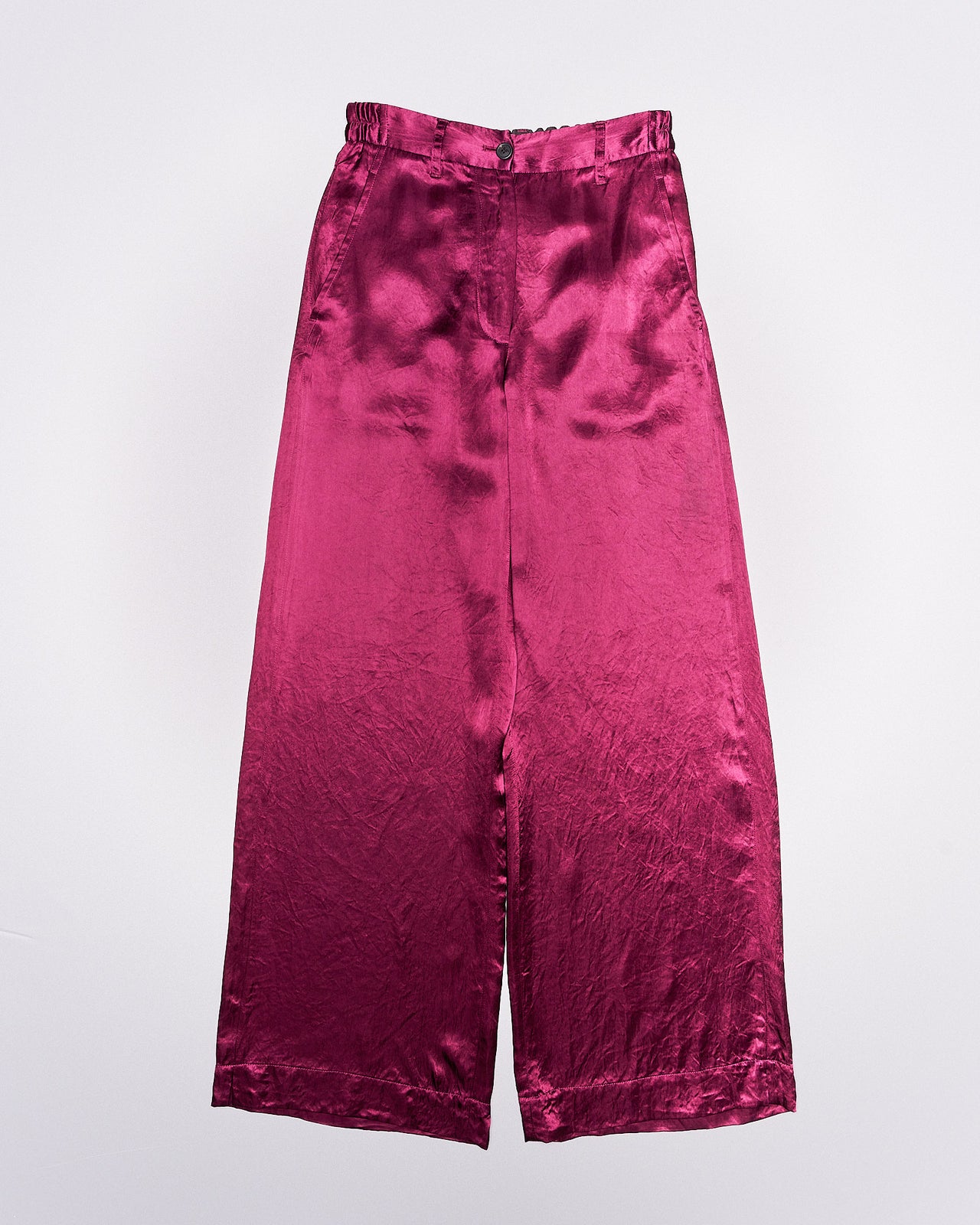 Magenta shiny Ann Demeulemeester pants with a high waist and loose fit, displayed against a plain white background. The fabric has a smooth, shiny texture.