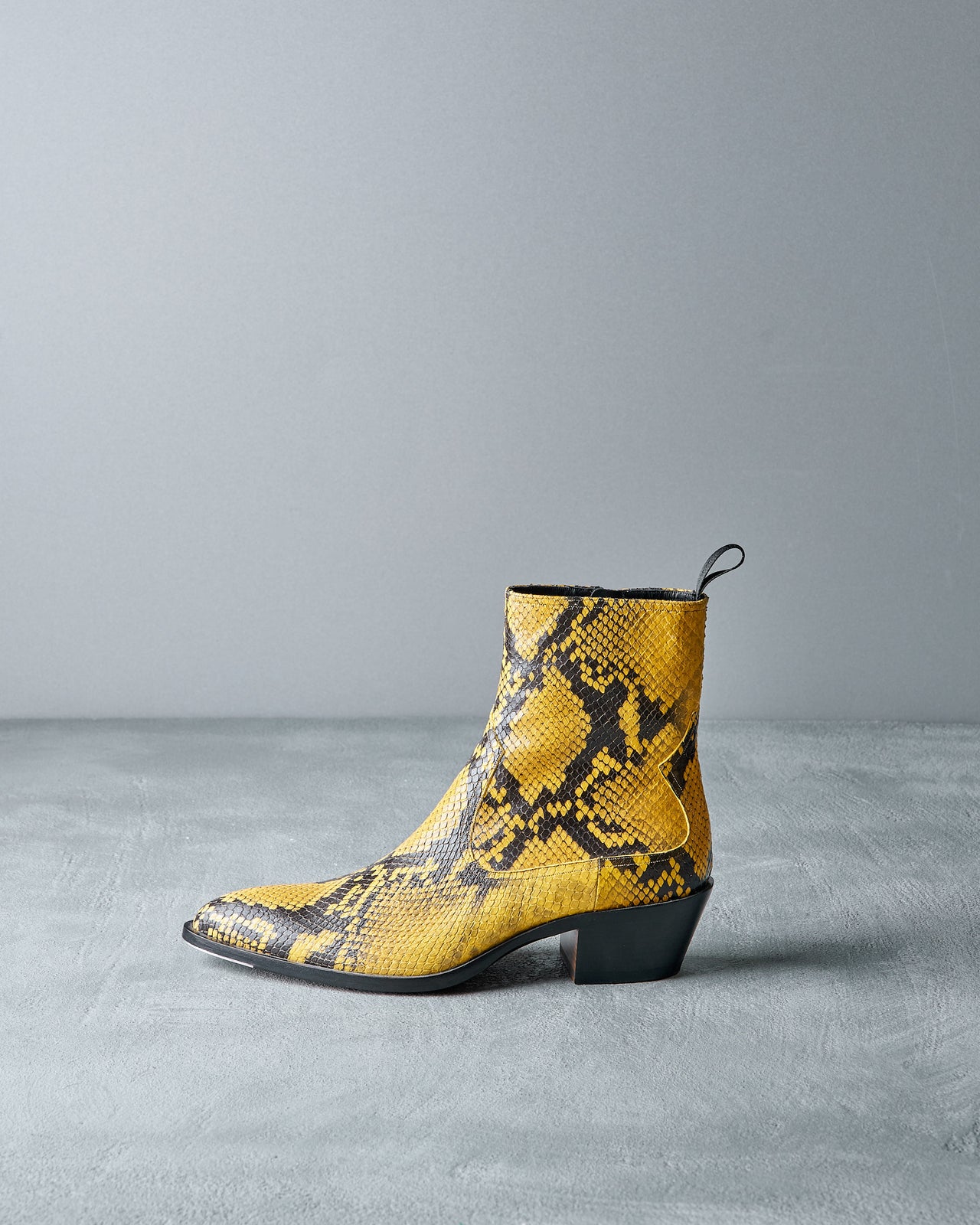 Yellow Bally snake print ankle boot on a gray background