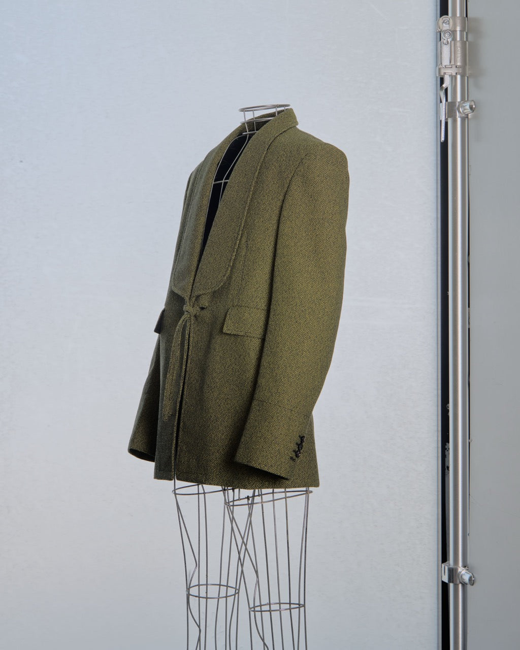 Yellow Bottega Veneta blazer on a mannequin against a light gray background