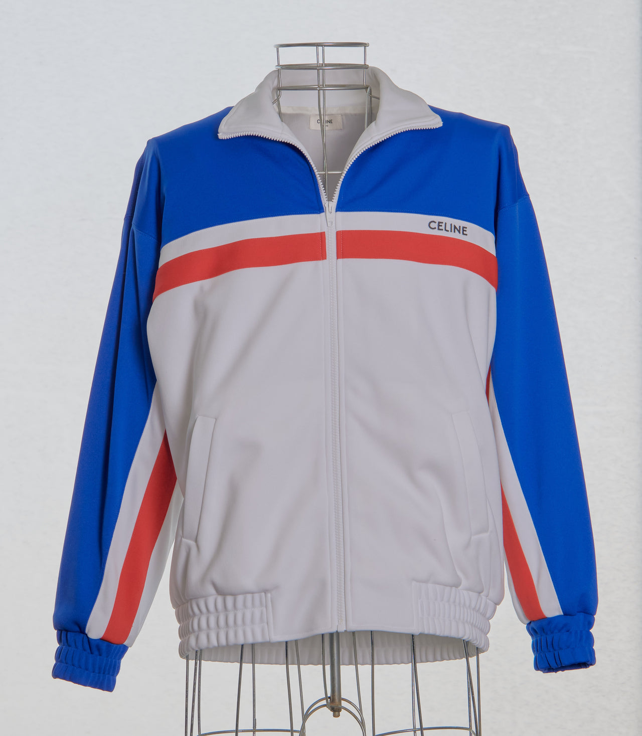 Colour-blocked Celine jacket with blue, white, and red stripes on a mannequin against a white background