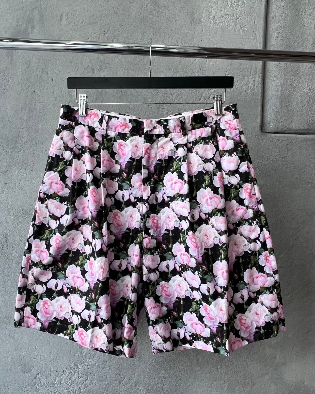 Person wearing a floral Givenchy outfit in a barbershop setting