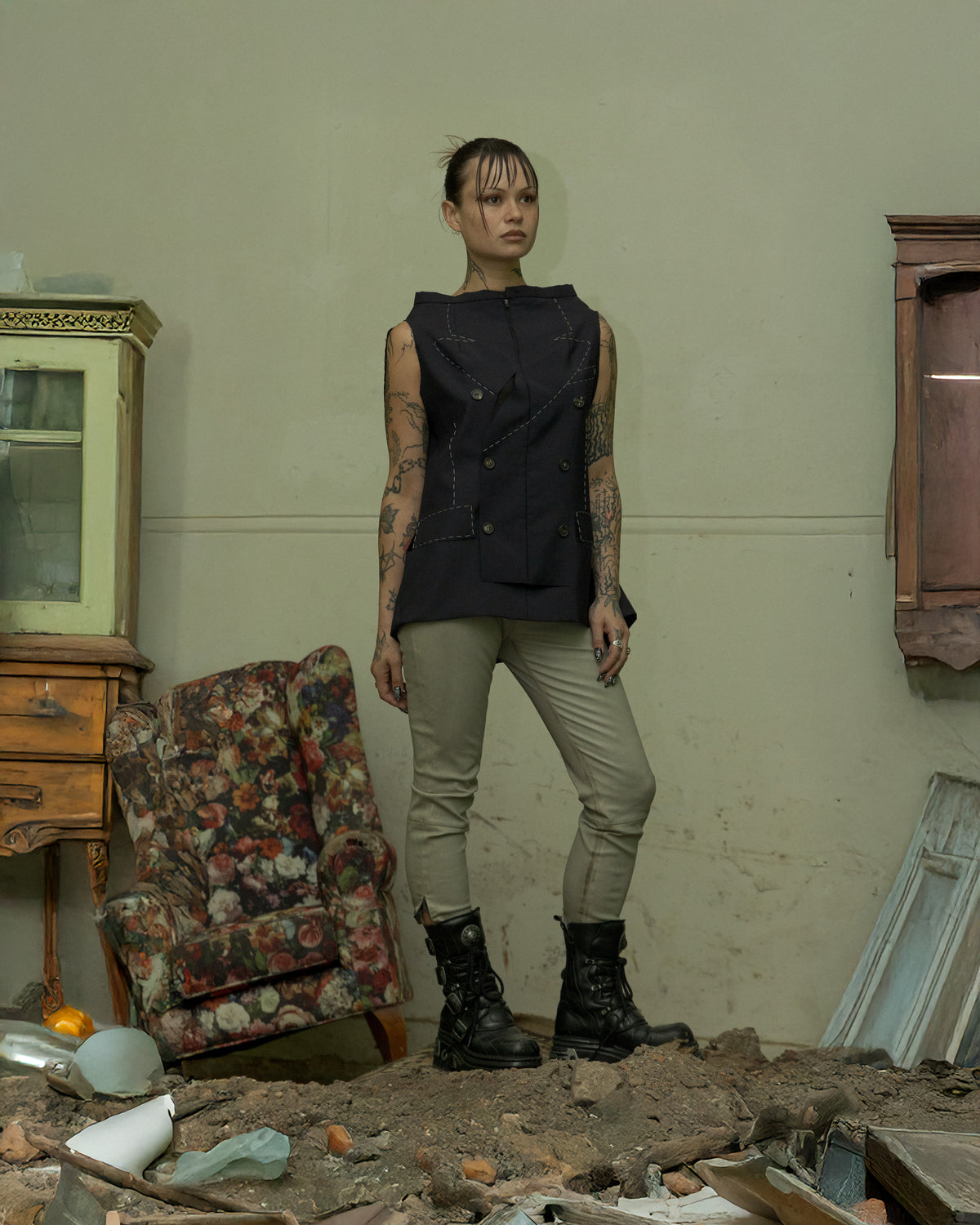 Person wearing Alexander McQueen beige pants with a blurred green background