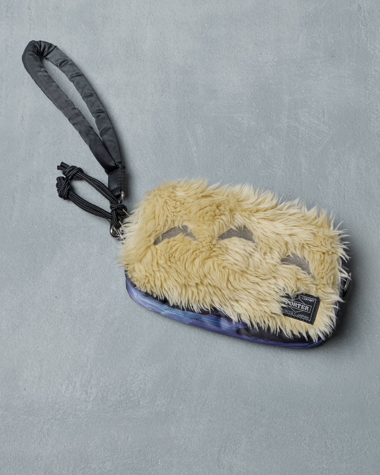 Furry Porter x Ghibli Totoro pouch with a strap on a gray background