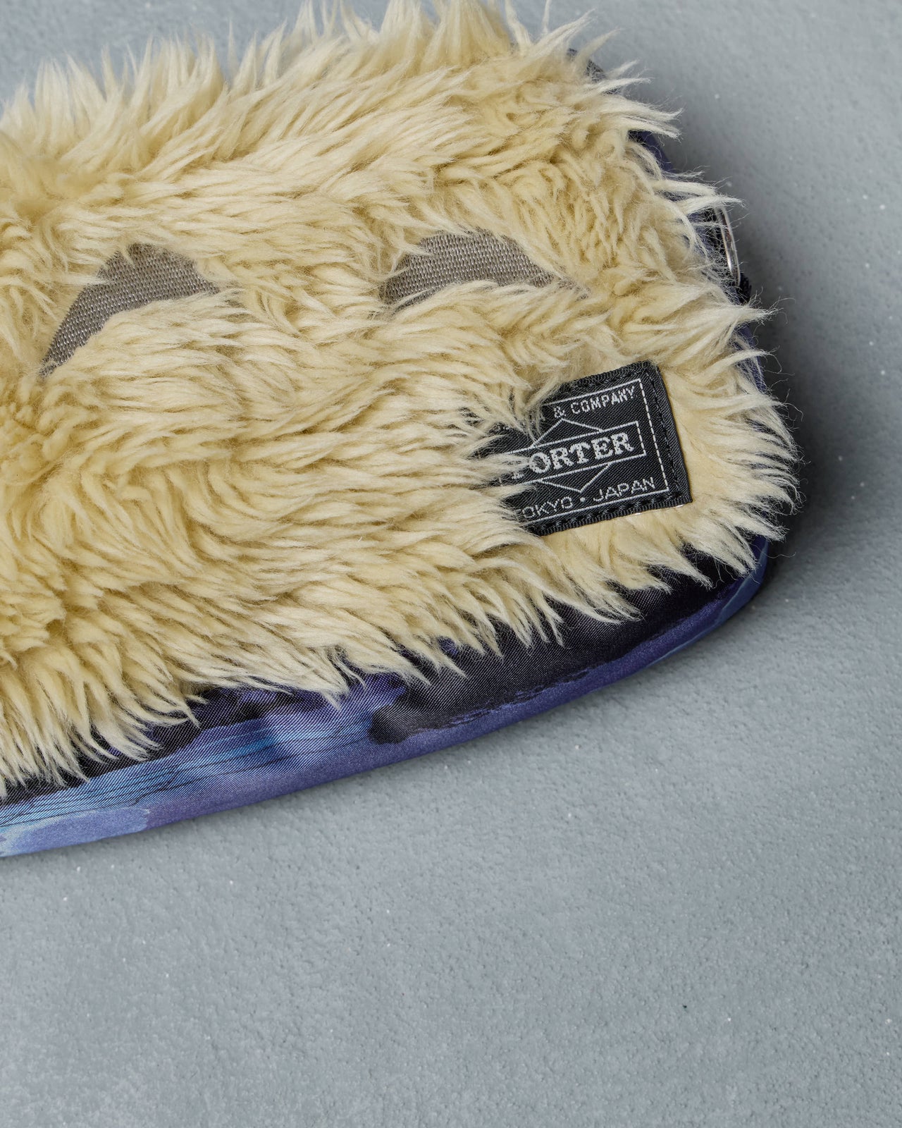 Furry Porter x Ghibli Totoro pouch with a strap on a gray background