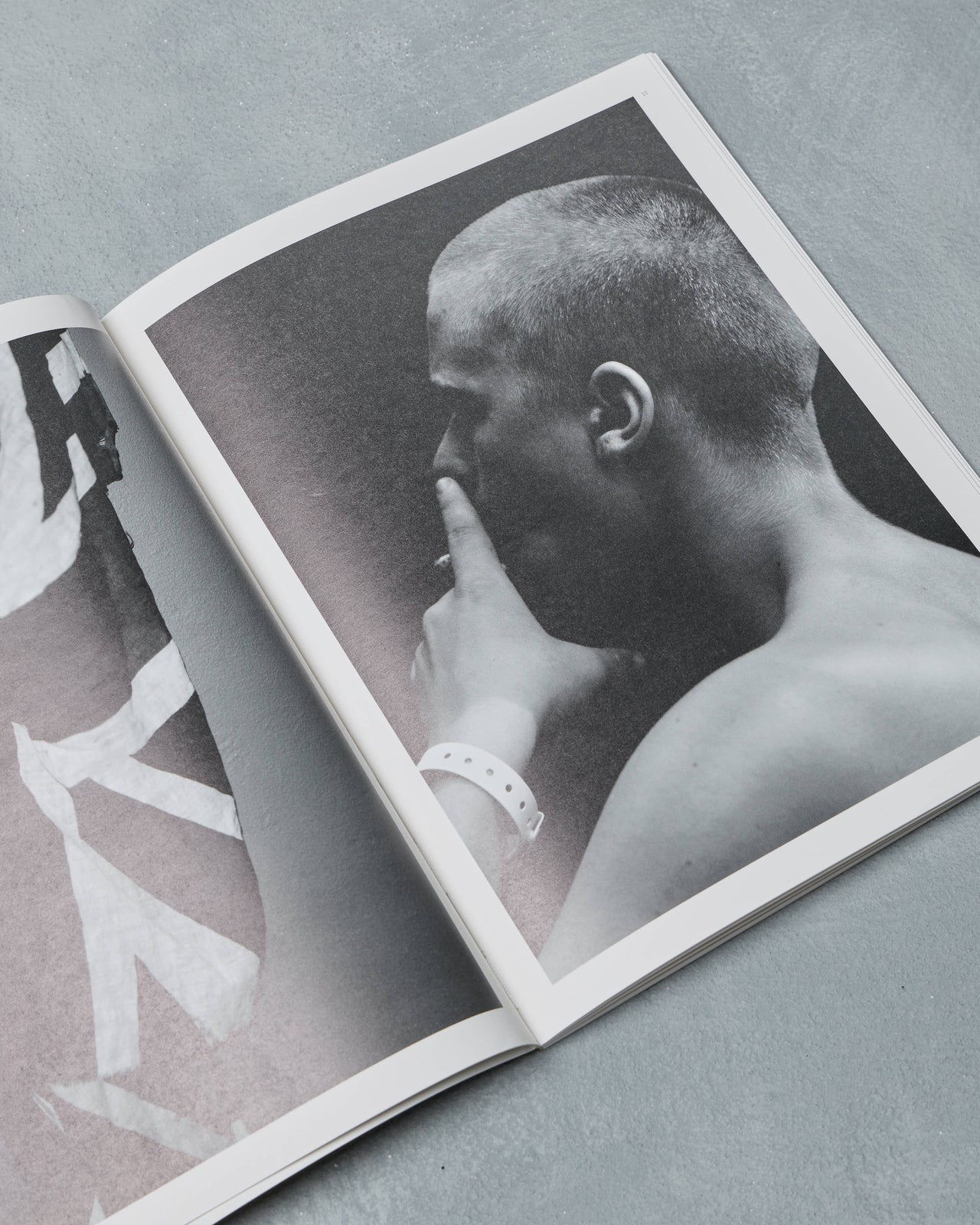 Ppaper Magazine cover with a person embracing and 'Hedi Slimane' text on a gray background