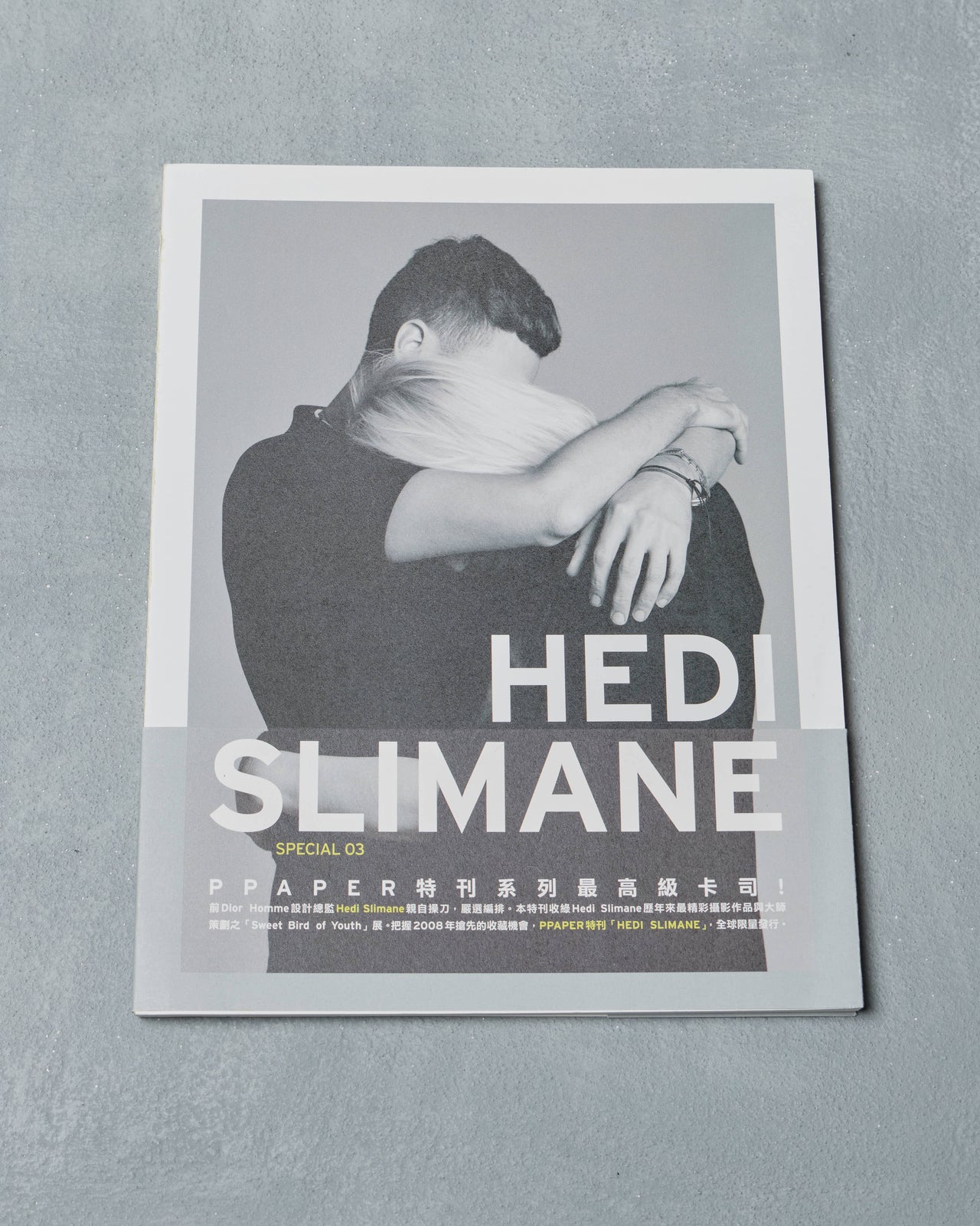 Ppaper Magazine cover featuring a person with 'Hedi Slimane' text on a gray background