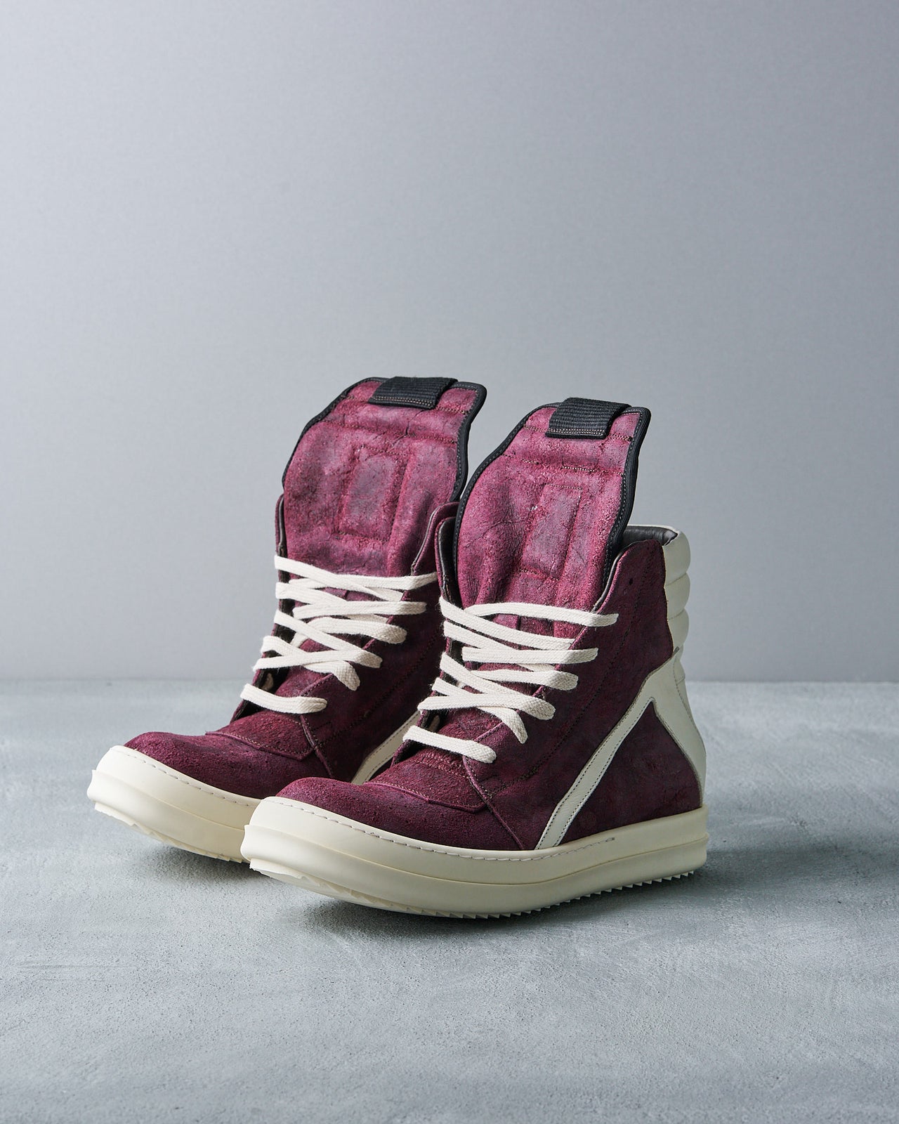 A Rick Owens Geobasket high-top sneaker with deep burgundy suede, white leather accents, and matching sole.
