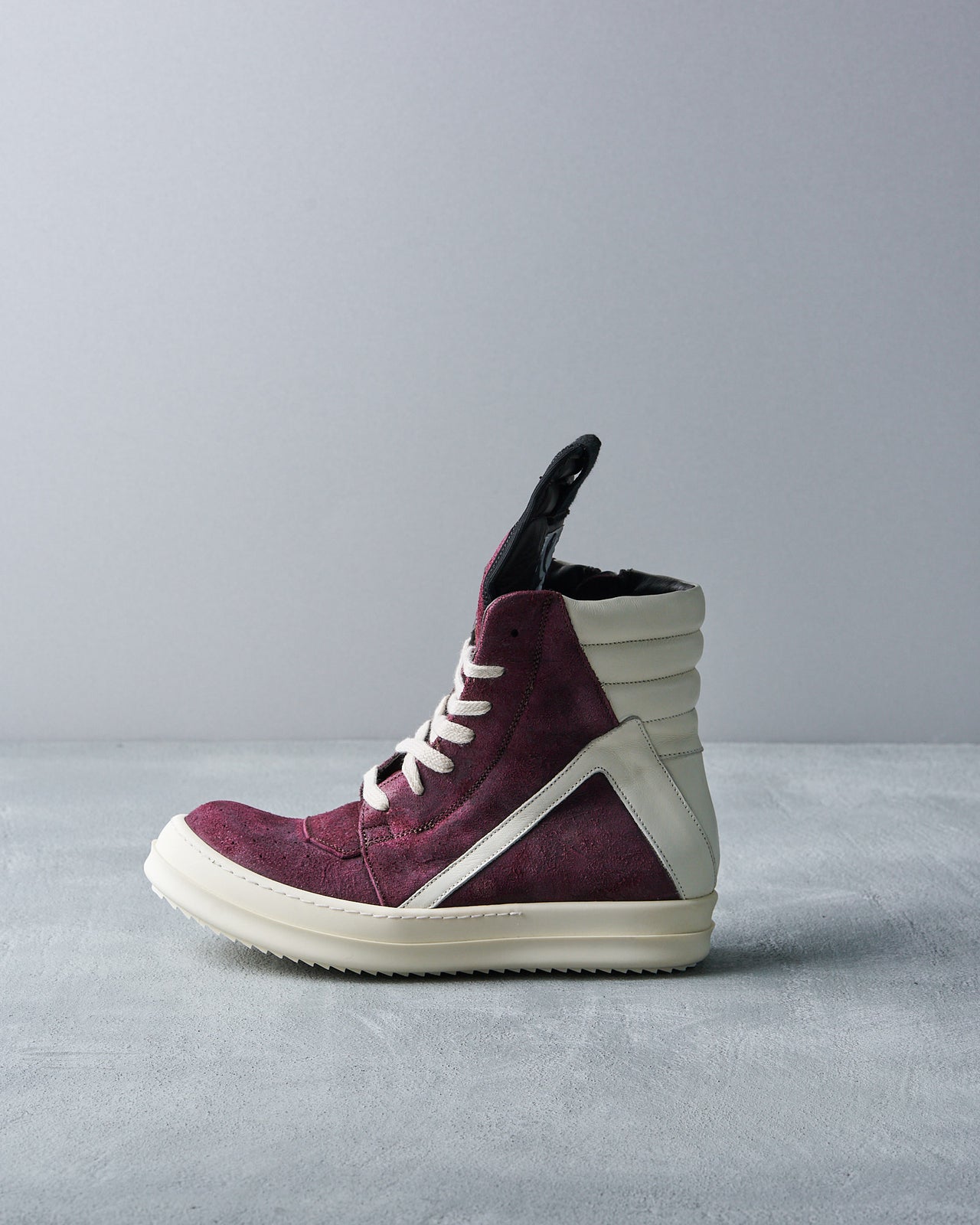 A Rick Owens Geobasket high-top sneaker with deep burgundy suede, white leather accents, and matching sole.