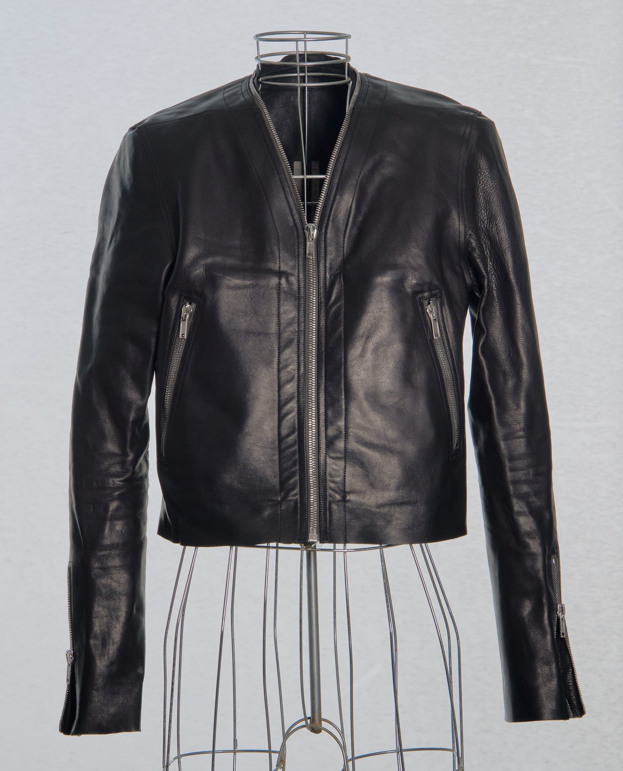 Black leather Rick Owens jacket on a mannequin against a light gray background