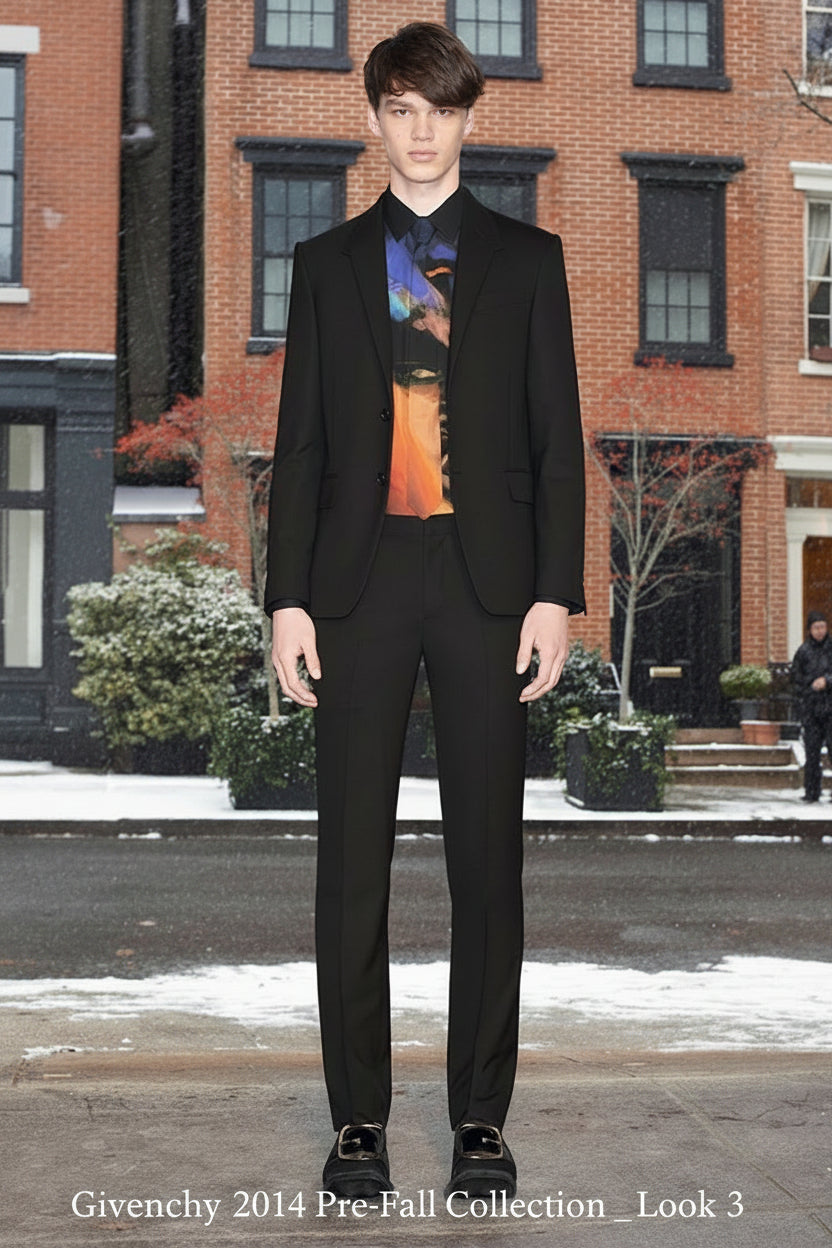 Colorful Givenchy shirt with artistic design of a face on a hanger against a neutral background