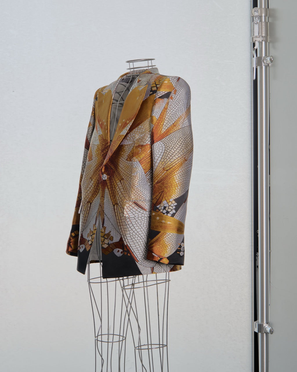Patterned Alexander McQueen jacket on a mannequin against a white background