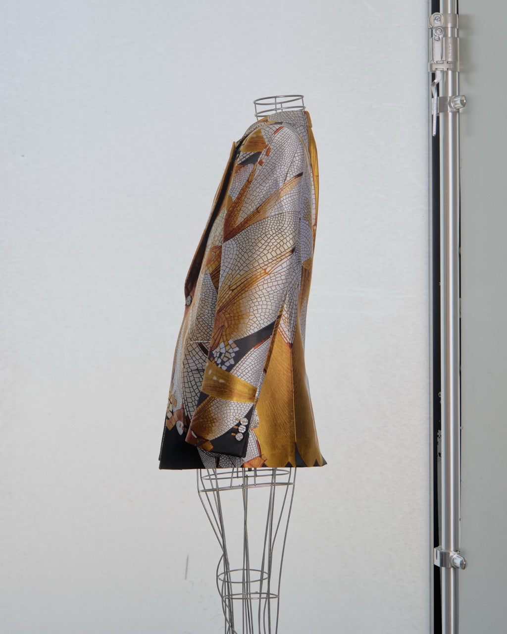 Alexander McQueen blazer with abstract pattern on a mannequin against a white background