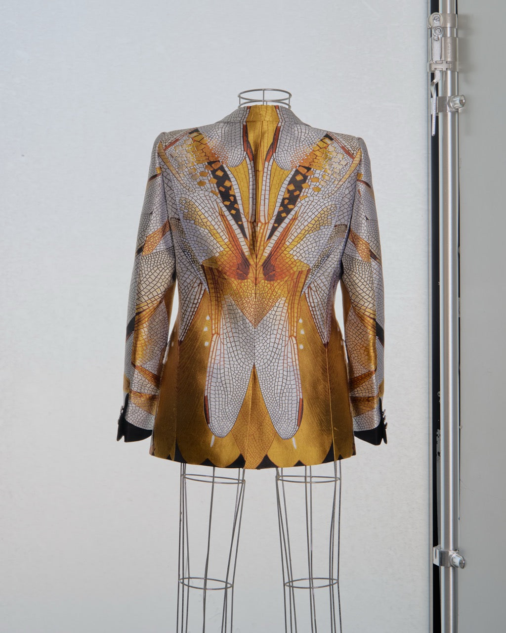 Patterned Alexander McQueen jacket on a mannequin against a plain background