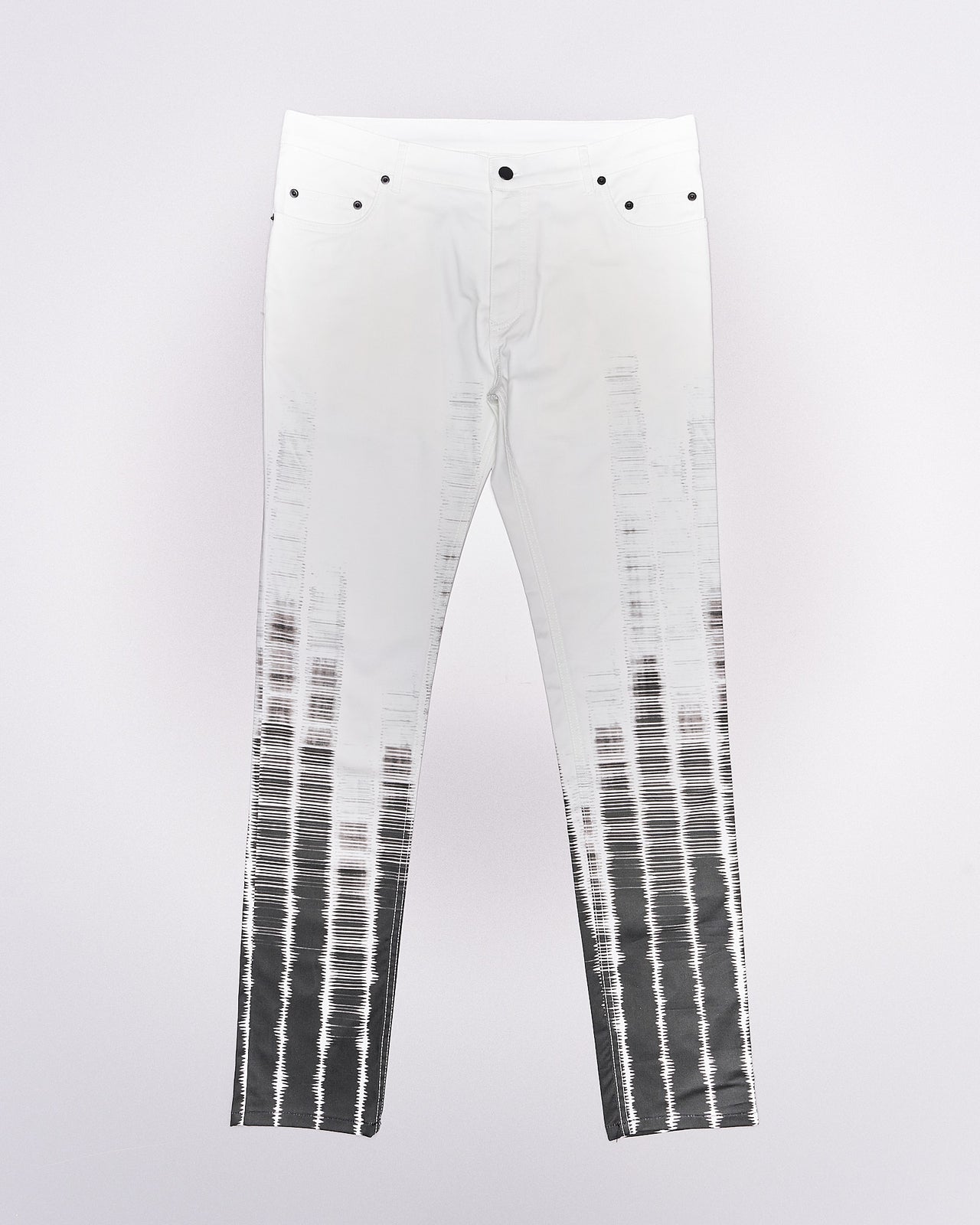 A pair of slim-fit Ann Demeulemeester tie-dye patterned trousers with button-fly closure and five-pocket styling, featuring contrasting press studs.