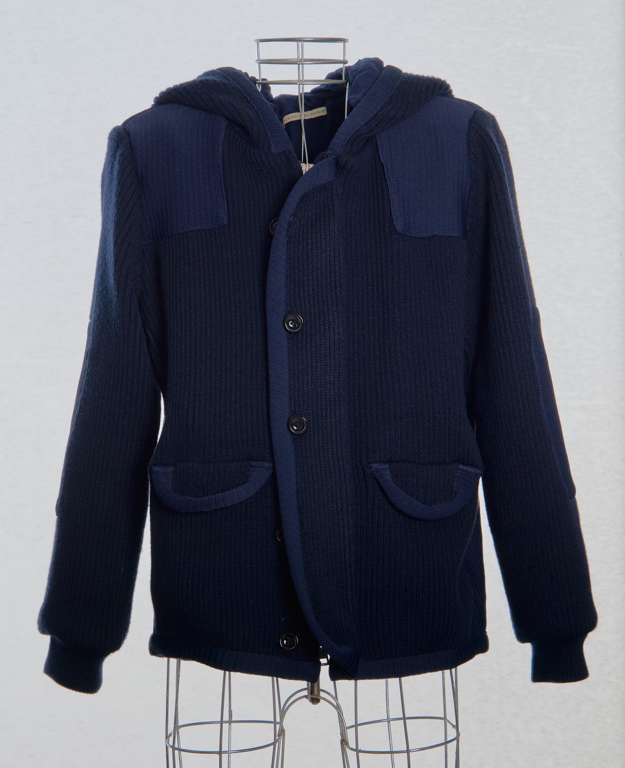 Navy blue hooded Balenciaga jacket on a mannequin against a white background