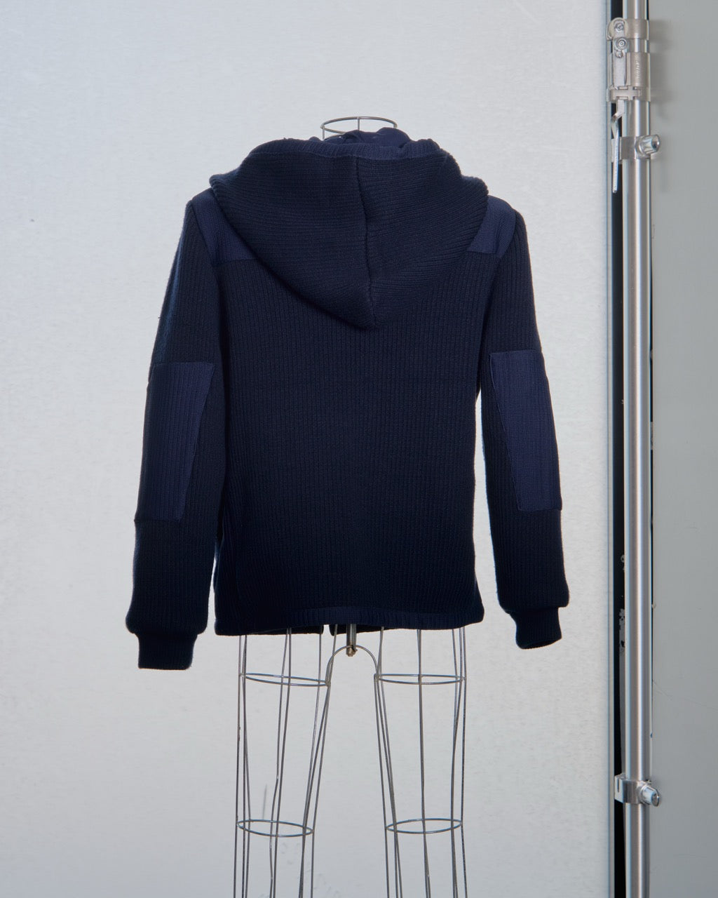 Navy blue Balenciaga hoodie on a mannequin against a plain background