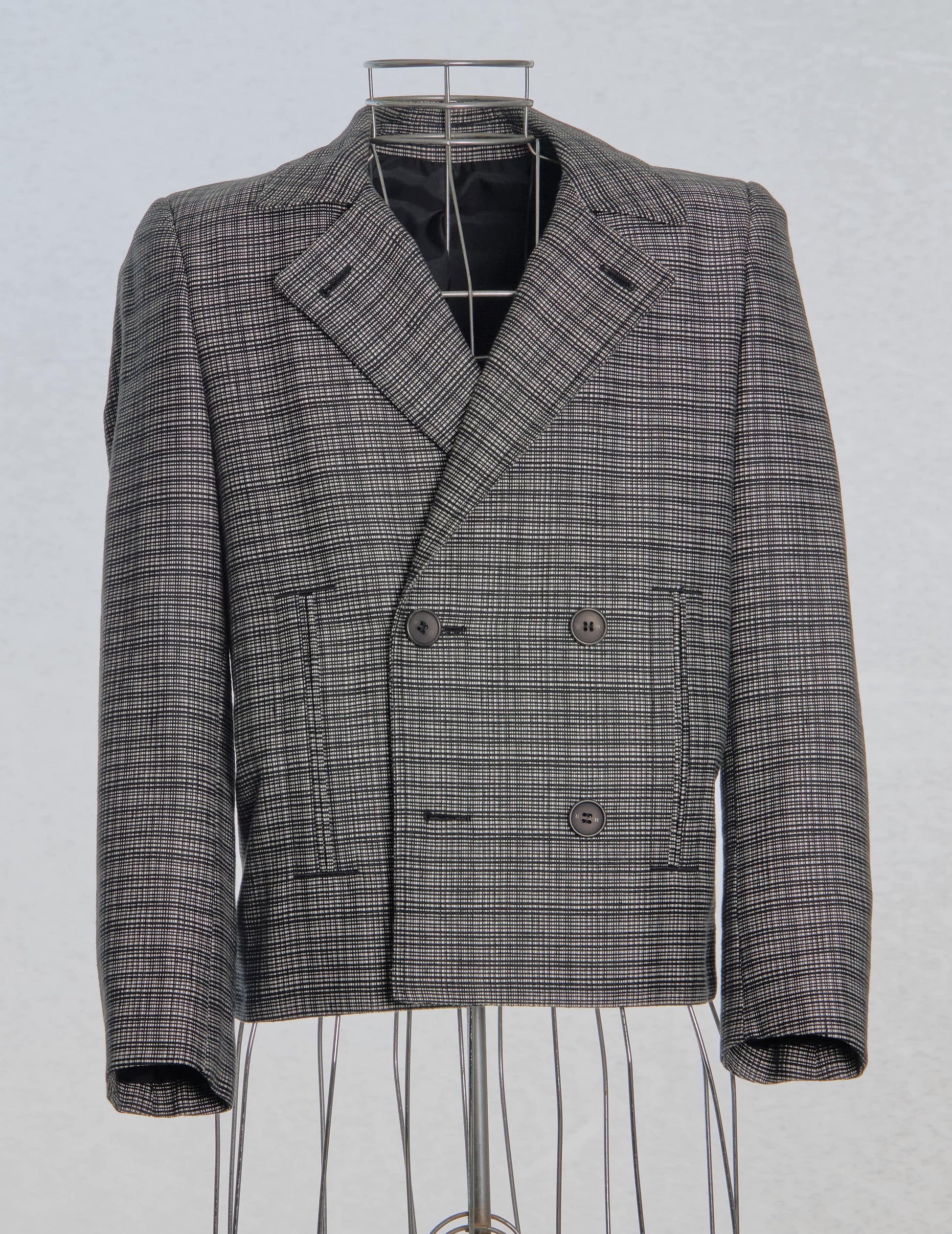 Gray Balenciaga checkered blazer on a mannequin against a light gray background