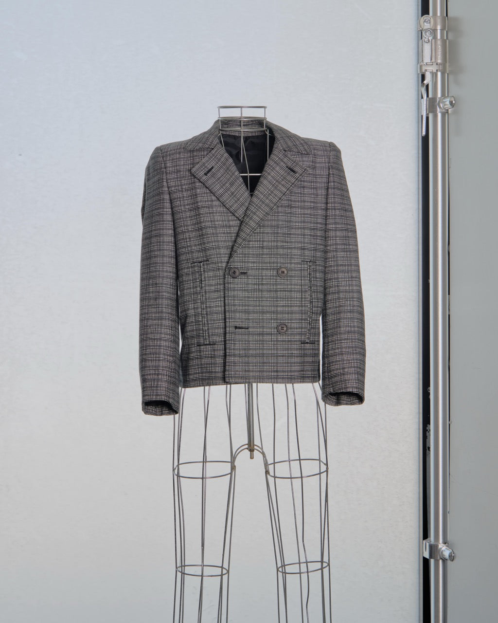 Plaid Balenciaga blazer on a mannequin against a plain background