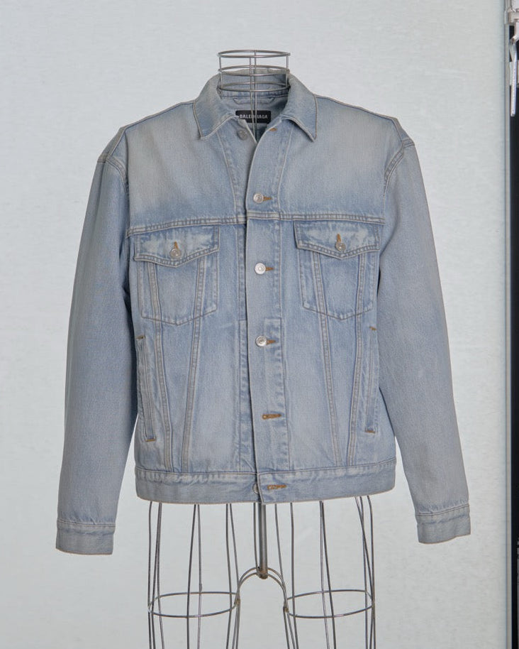 Light blue denim Balenciaga jacket on a mannequin against a plain background