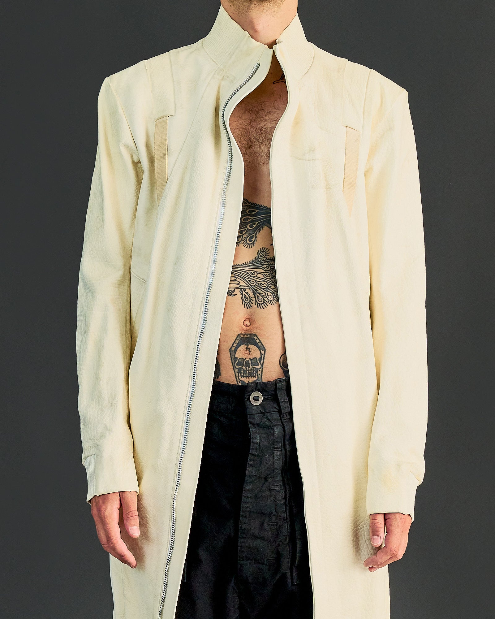 Unisex off-white long jacket with zip front, stand collar, and long sleeves by Boris Bidjan Saberi.