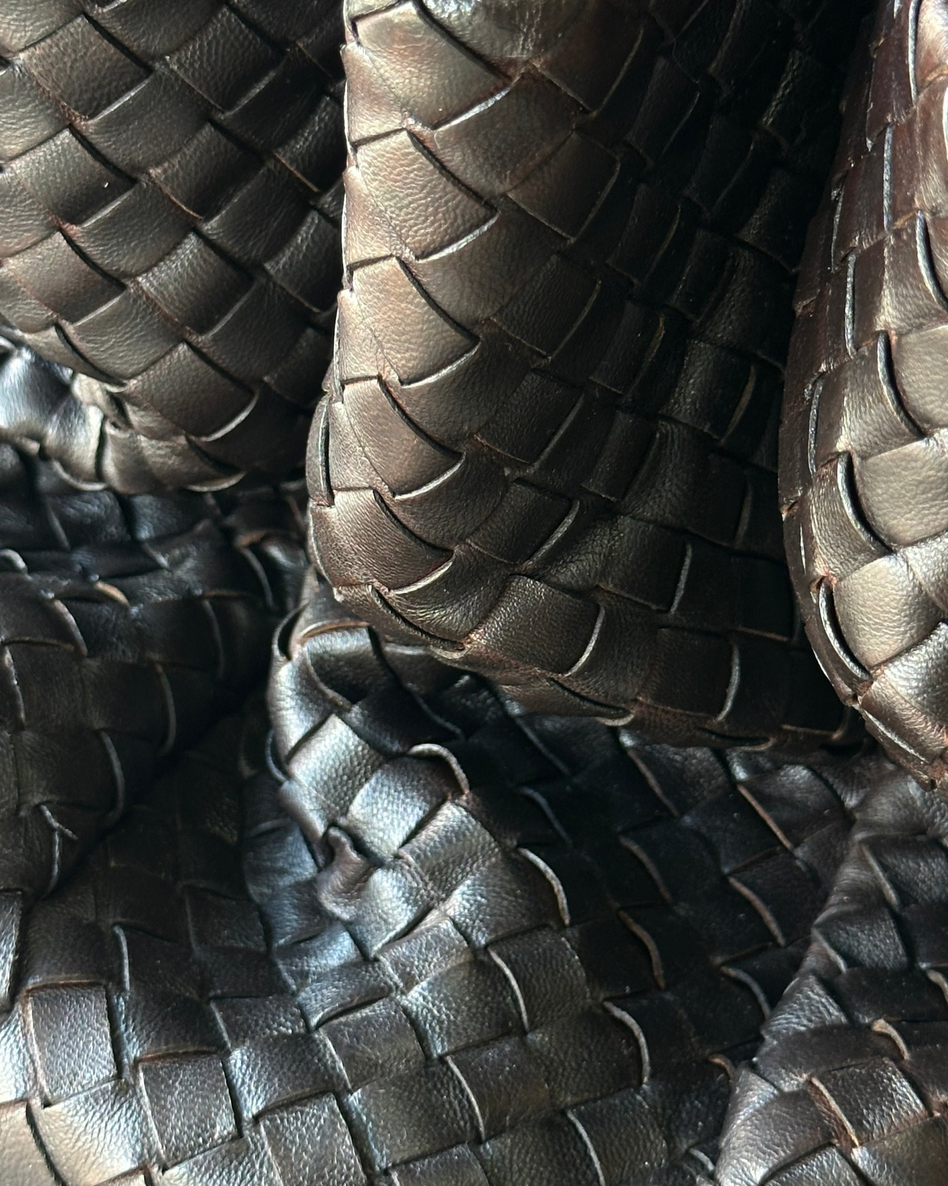 Close-up of brown black leather texture on a Bottega Veneta bag