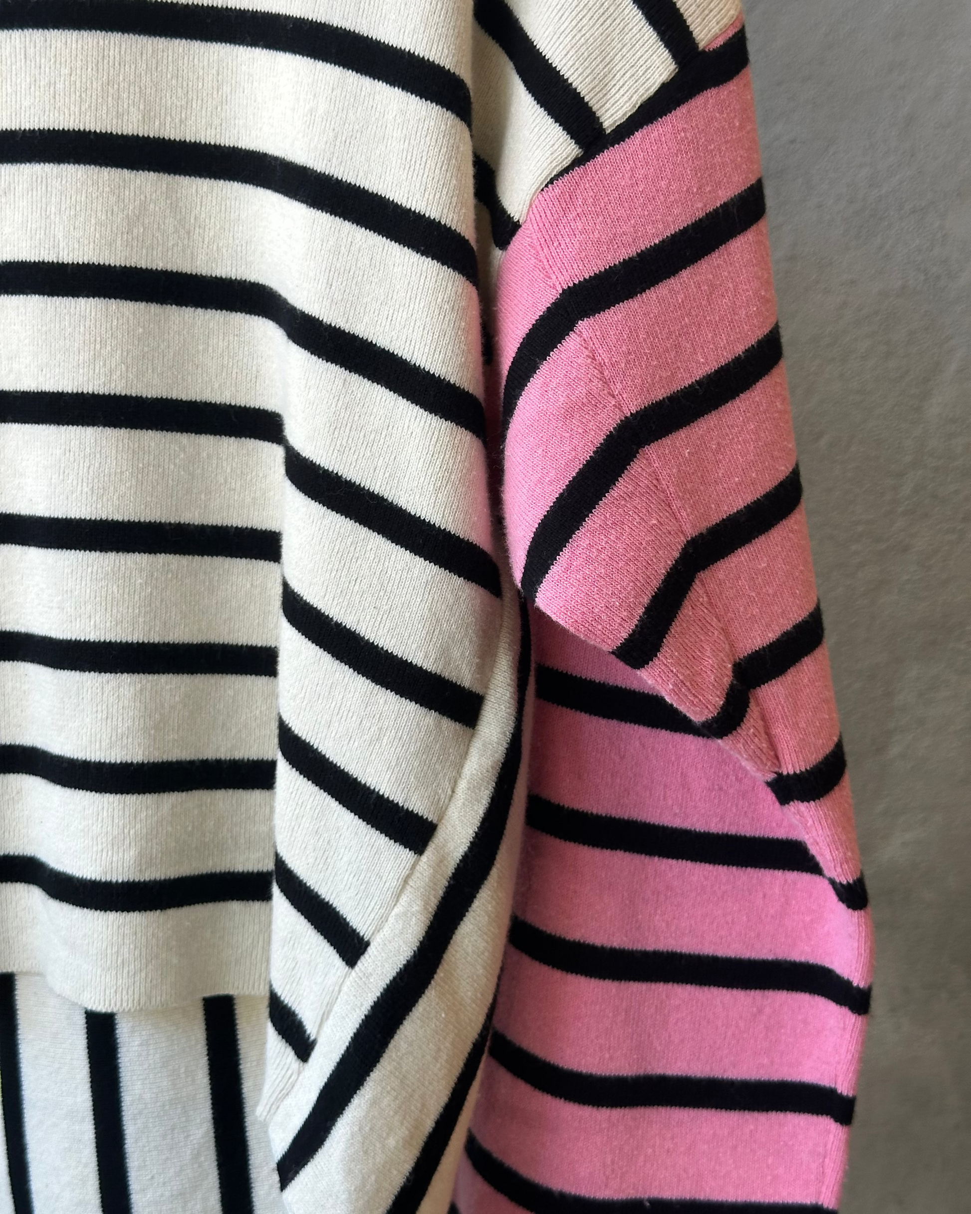 Striped Celine sweater against a grey wall