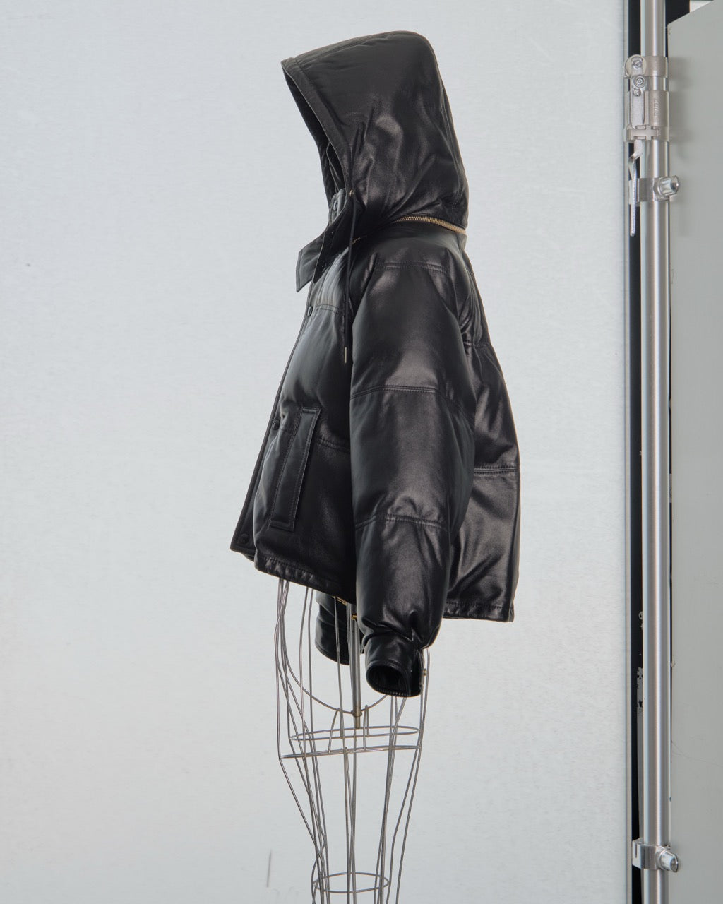 Black hooded Celine jacket on a mannequin against a white background