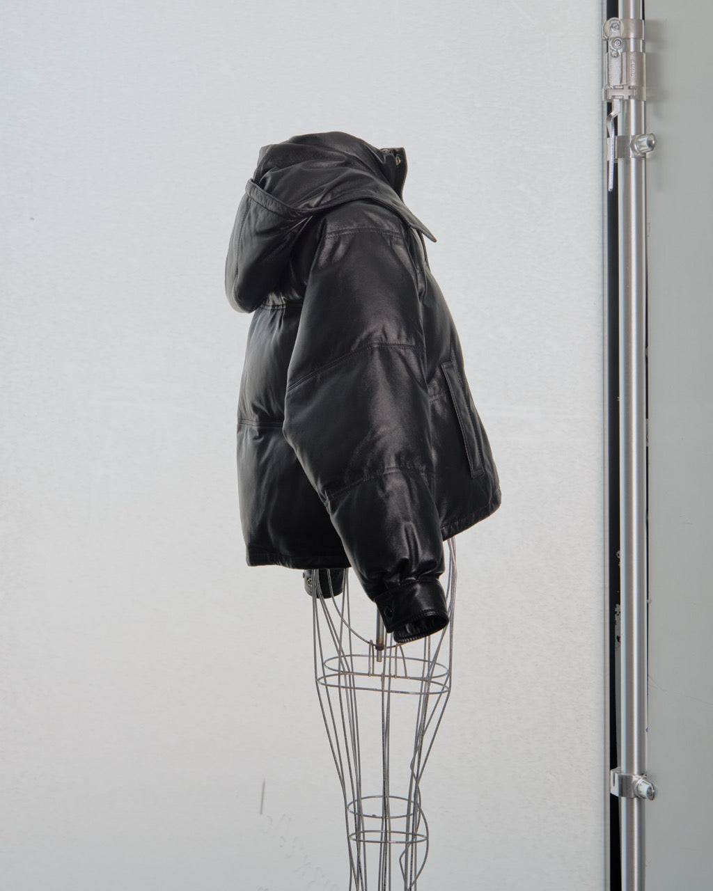 Black leather Celine jacket on a mannequin against a white background