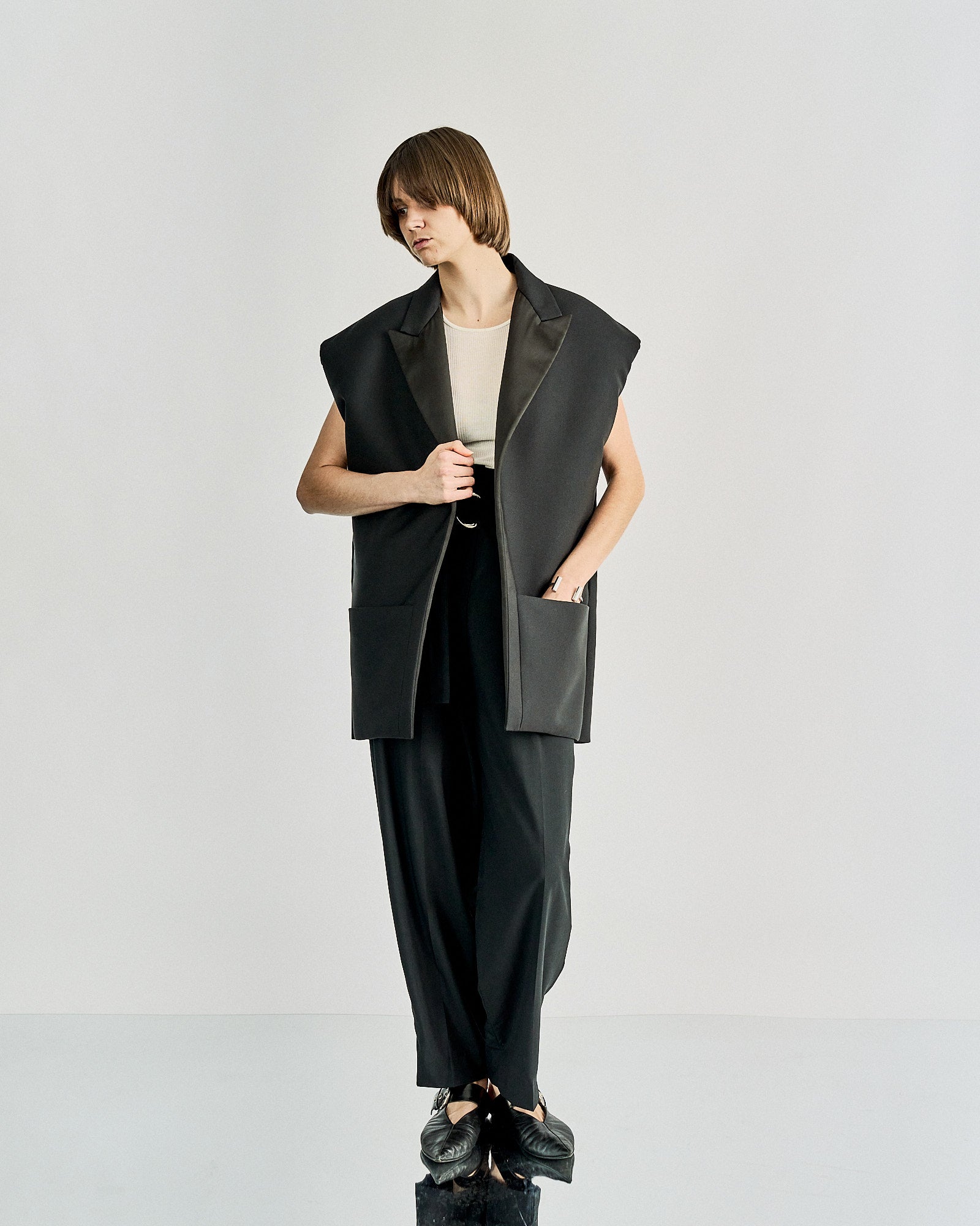 A sleeveless oversized black Celine blazer with exaggerated padded shoulders, peak lapel, and two external patch pockets. The blazer is displayed on a model against a white background.