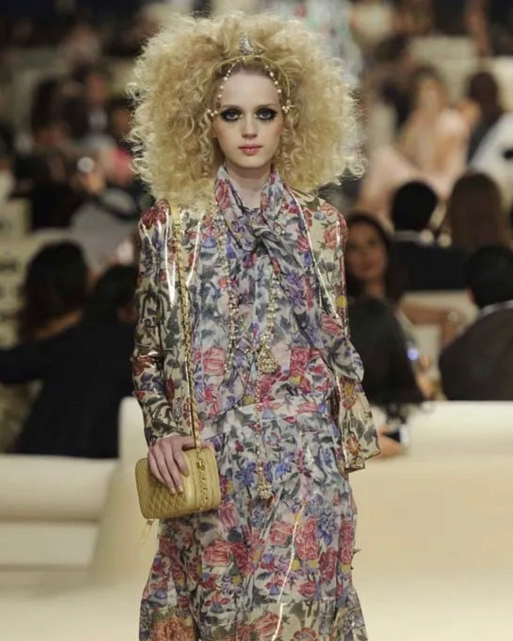 Model wearing a floral outfit on a Chanel runway