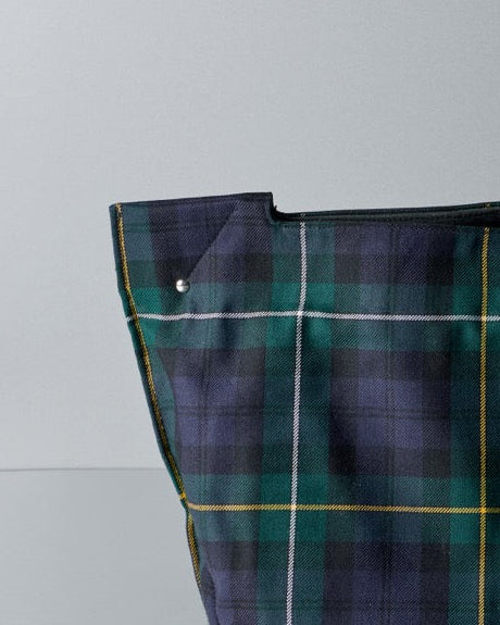 Plaid Comme des Garcons bag on a gray background