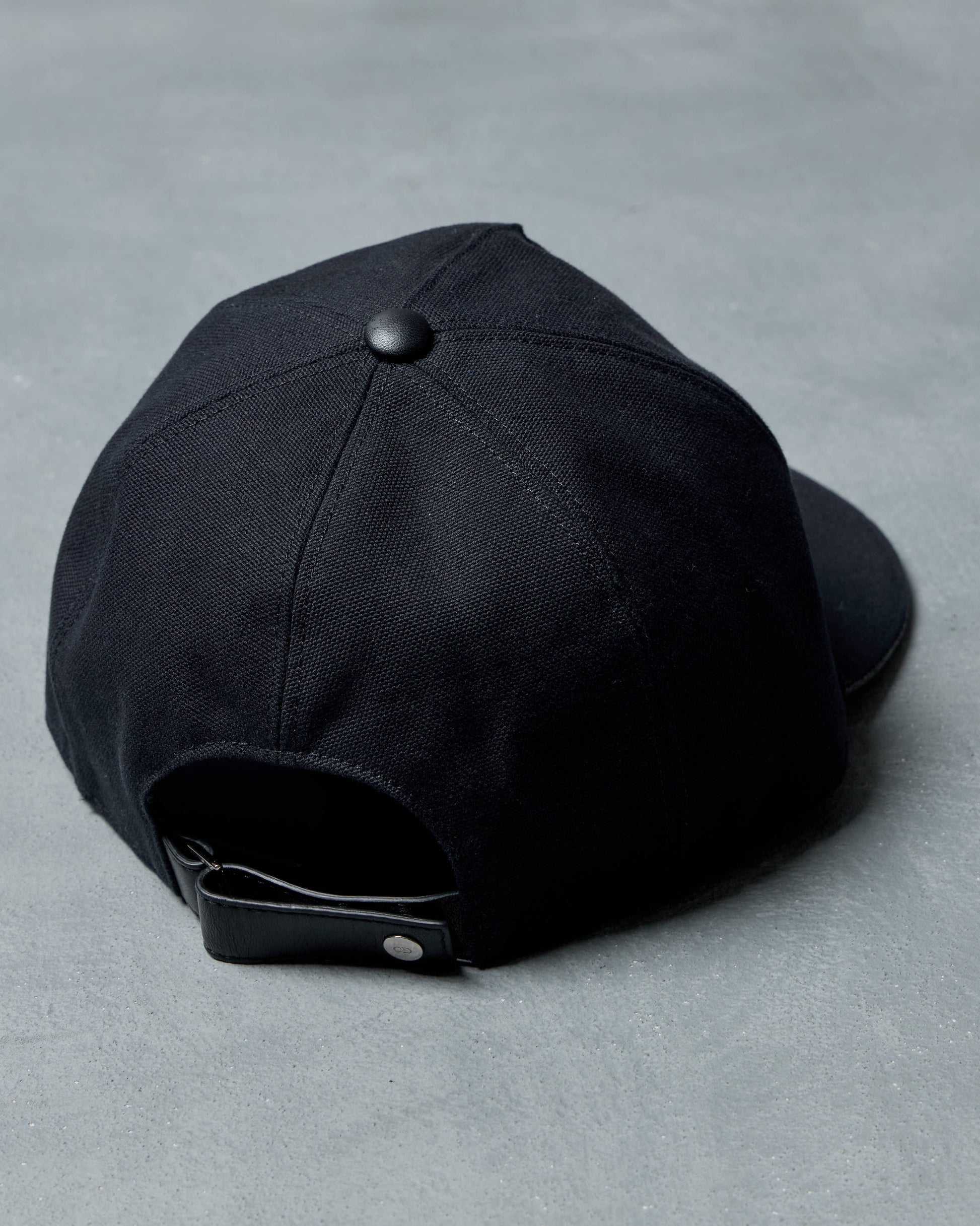 Black Dior cap on a gray background