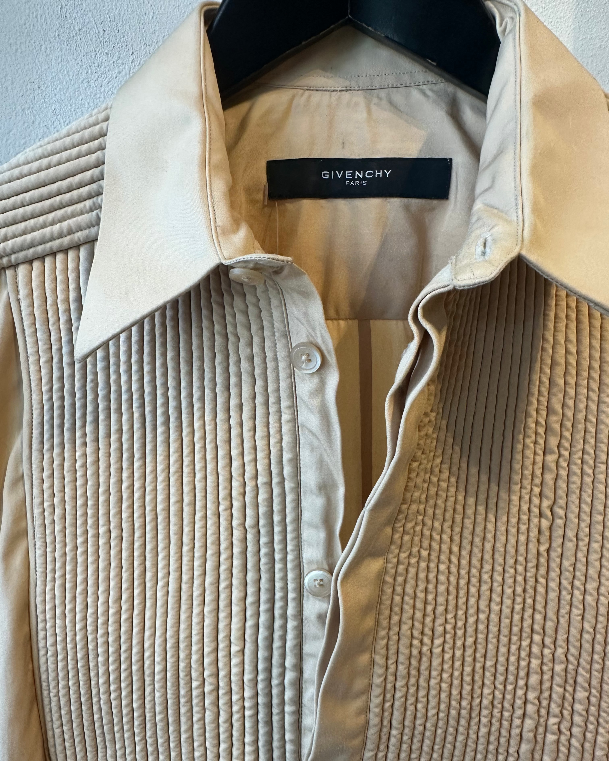 Beige corduroy shirt with Givenchy label on a light gray background