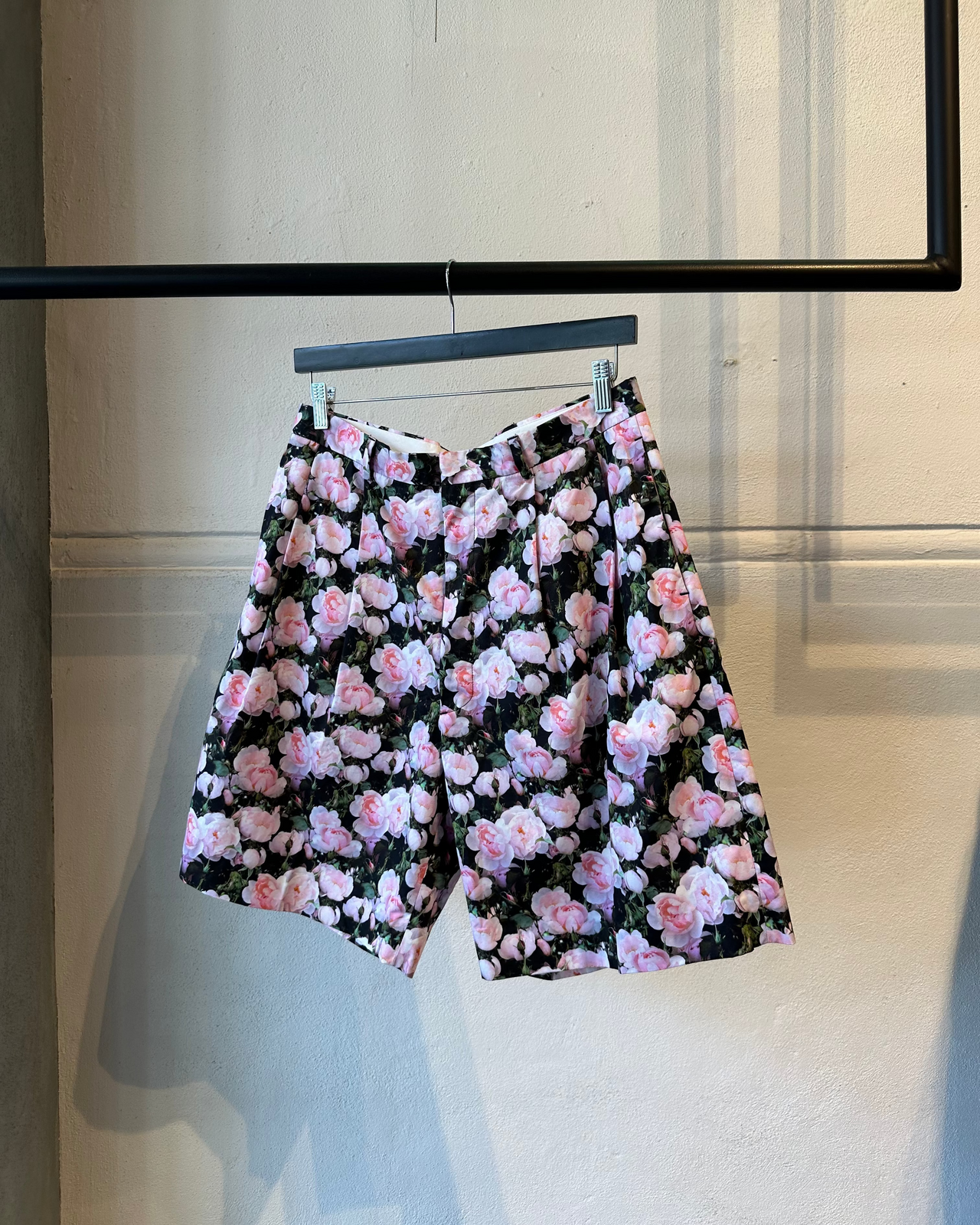 Person wearing a floral Givenchy outfit in a barbershop setting