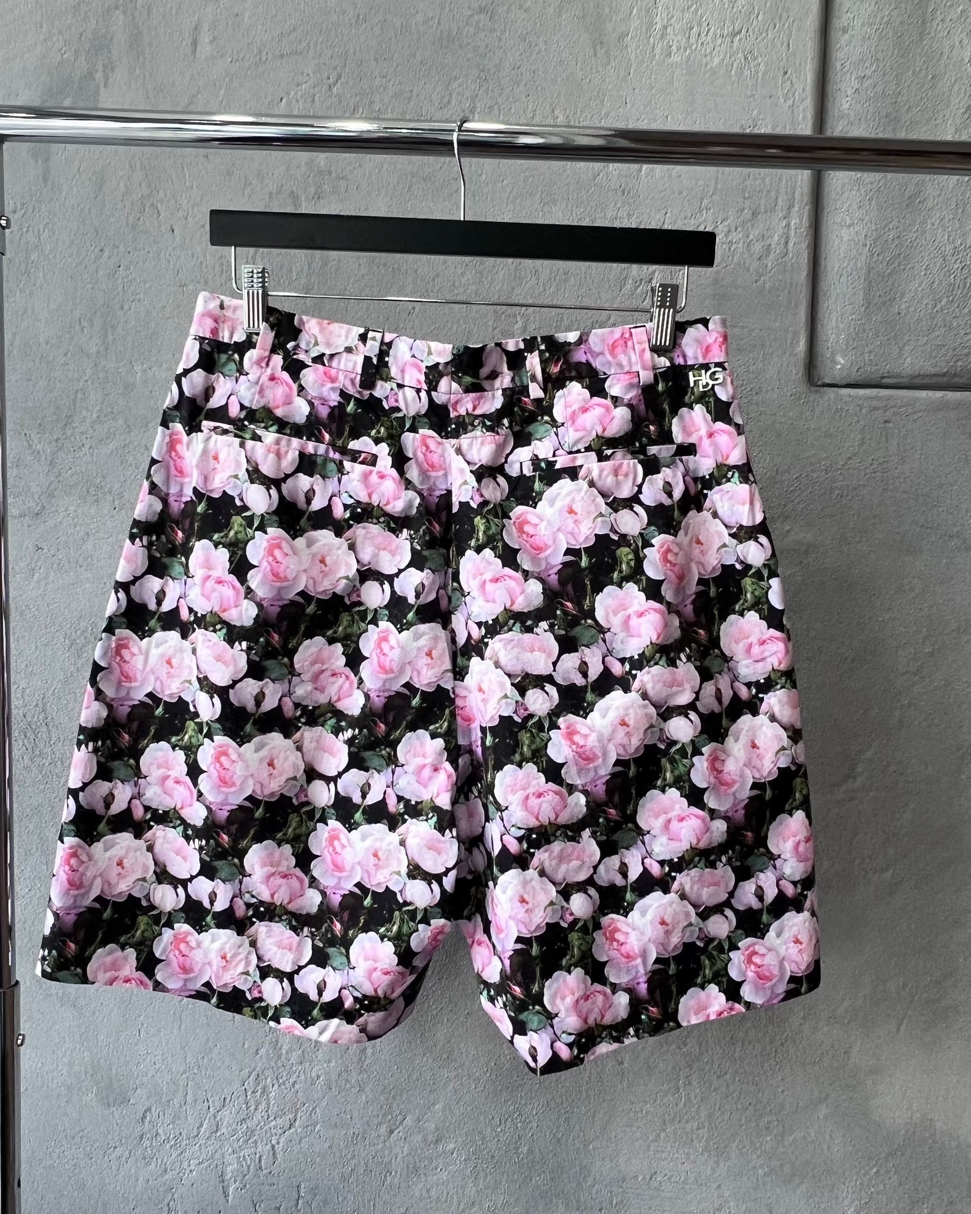 Floral Givenchy shorts with pink flowers on a gray surface
