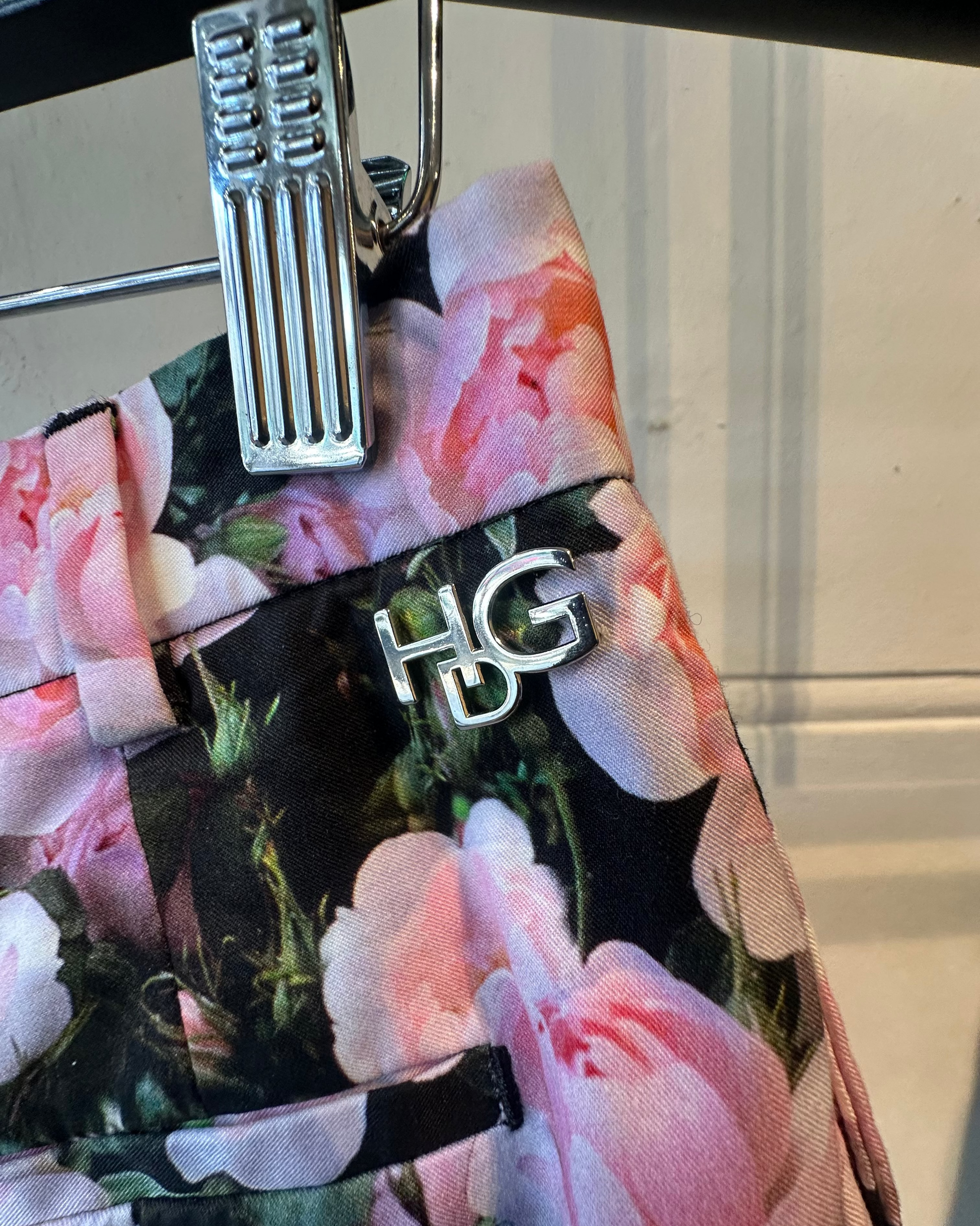 Up close of floral-pattern on Givencgy shorts with a visible brand logo on a neutral background