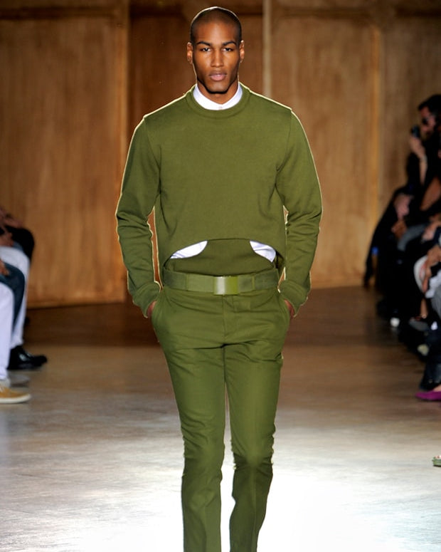 Man wearing a green Givenchy outfit on a runway