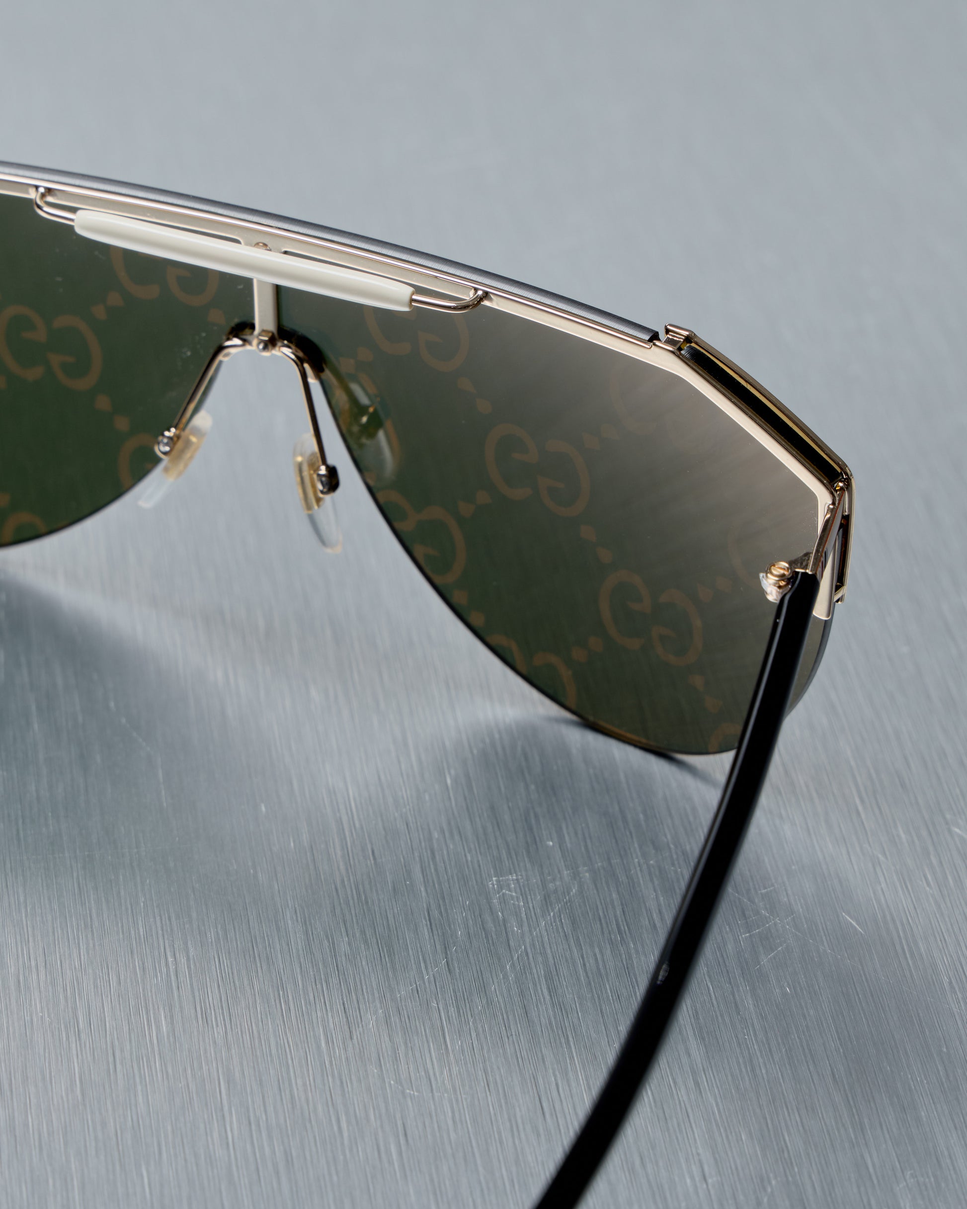Gucci mirrored Sunglasses with a brand logo on the gray background