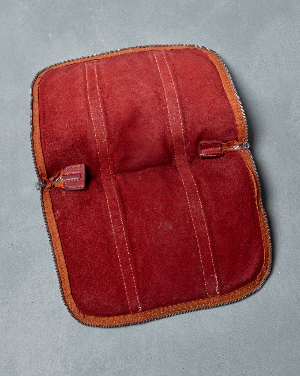 Red leather Guidi pouch on a gray background