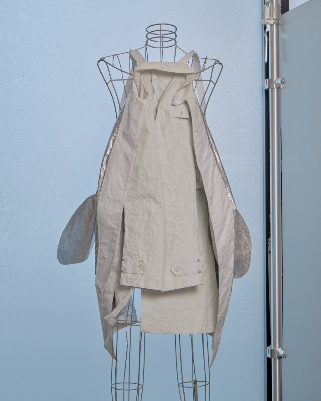 White Helmut Lang jacket on a mannequin against a light blue wall