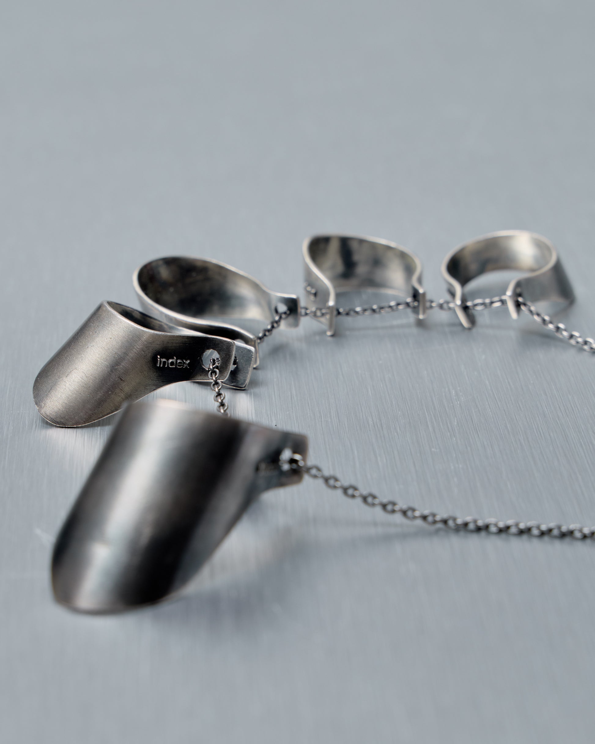 Silver necklace from Julius with chain on a gray background