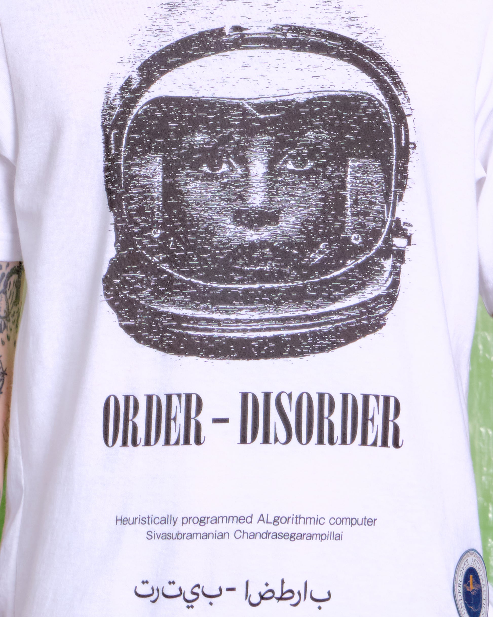 White t-shirt with black astronaut graphic and text on a white background