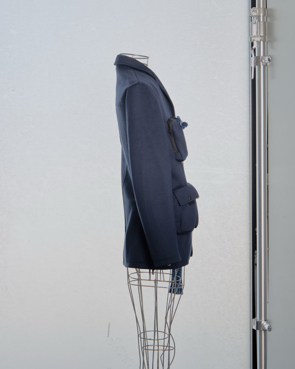 Navy blue Lanvin coat on a mannequin against a white wall