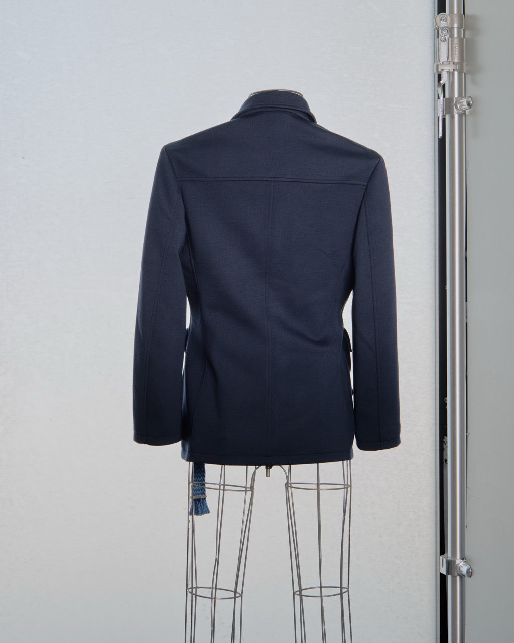 Navy blue Lanvin jacket on a mannequin against a plain background