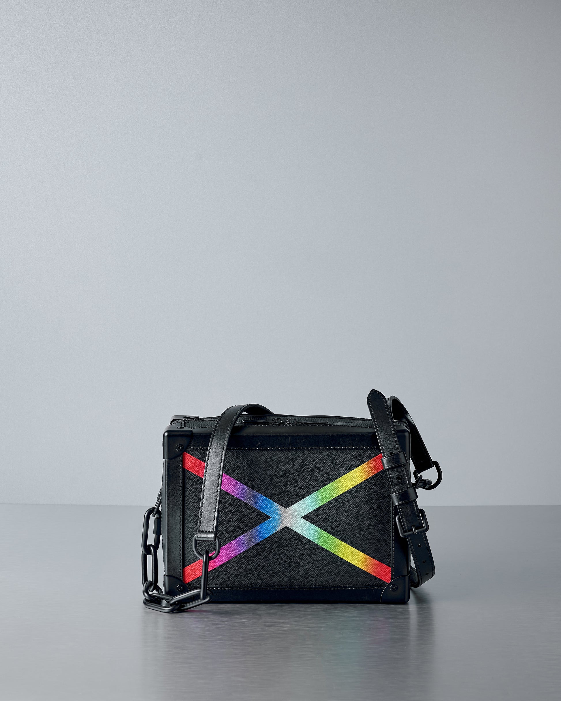Black Louis Vuitton handbag with a colourful abstract design on a gray background