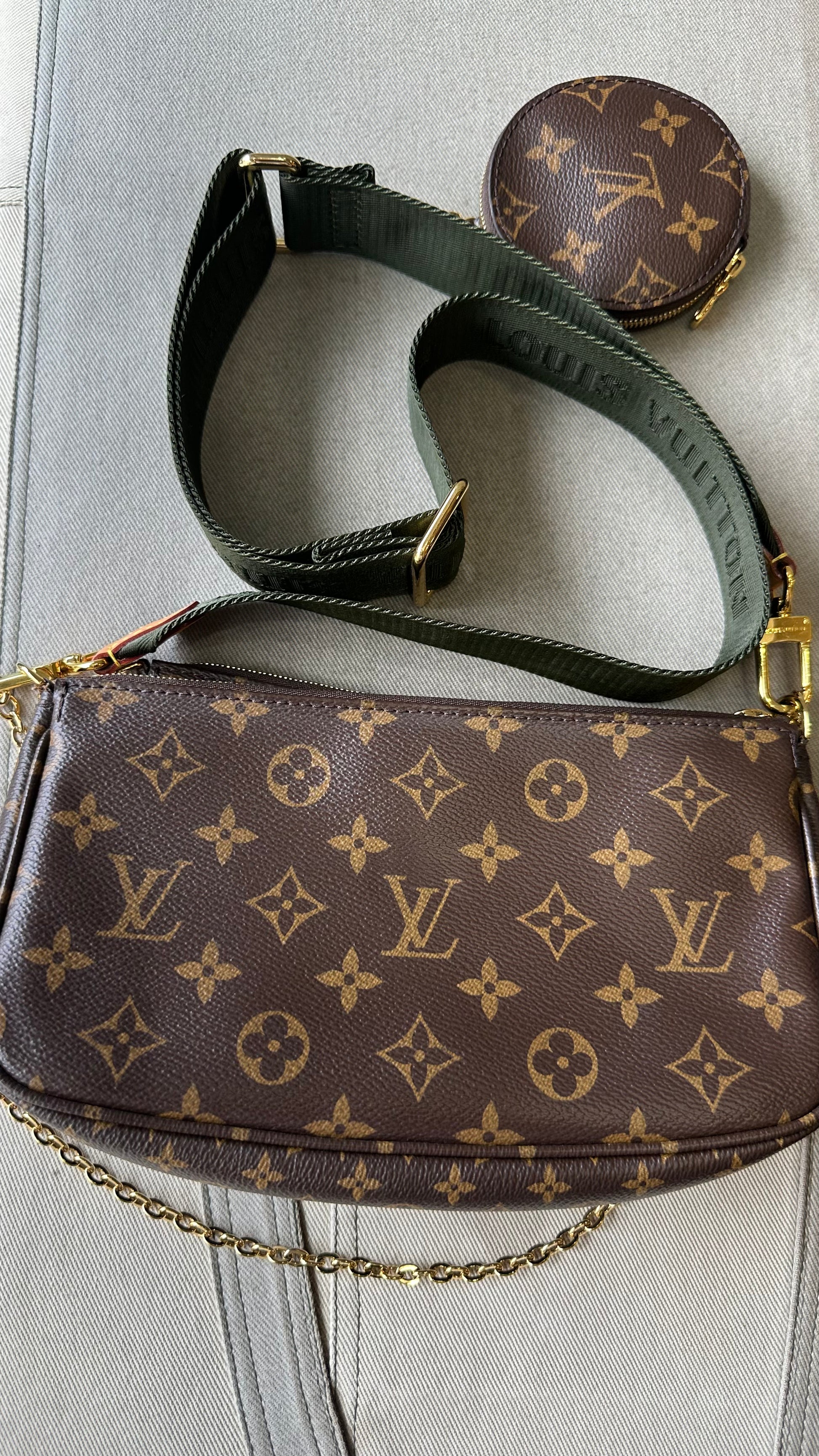 Louis Vuitton handbag with monogram pattern on a light gray background