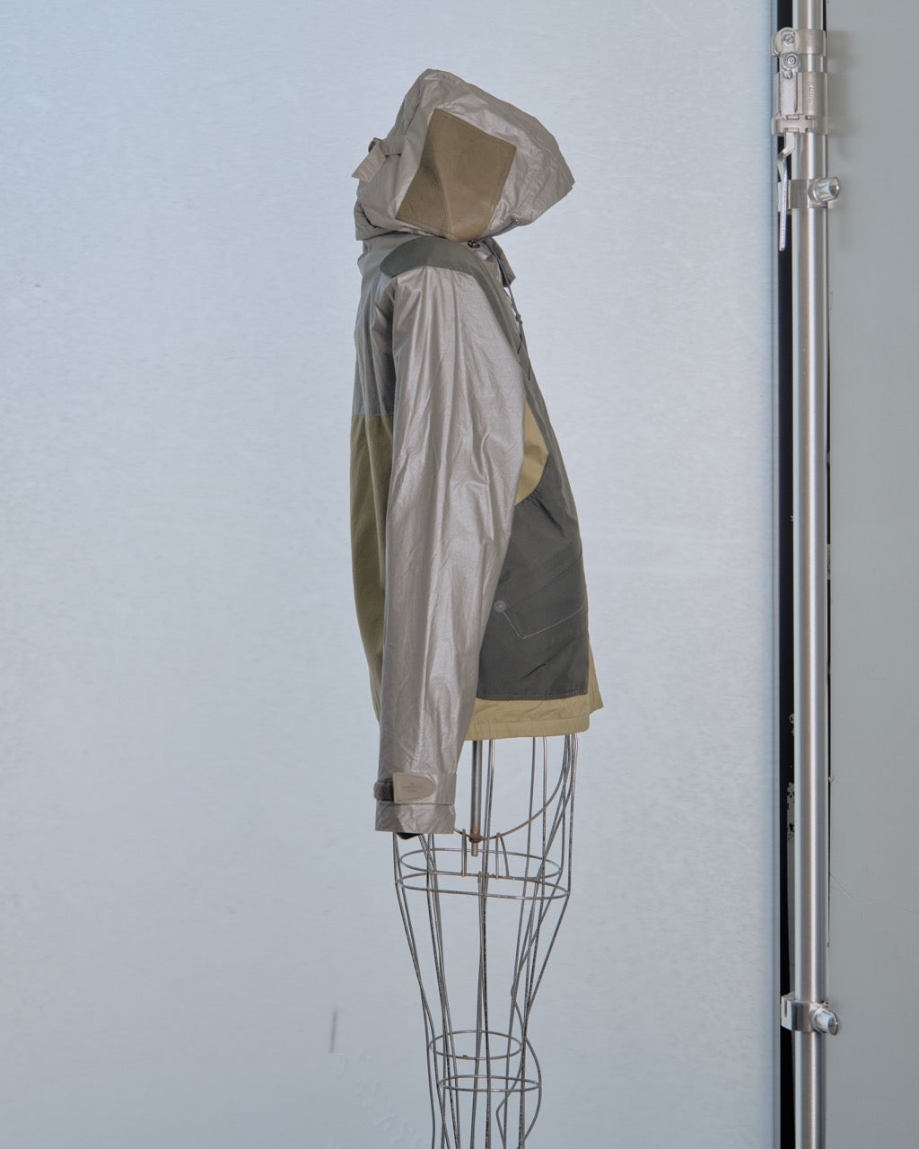 Multicoloured Louis Vuitton jacket on a wire mannequin against a plain background